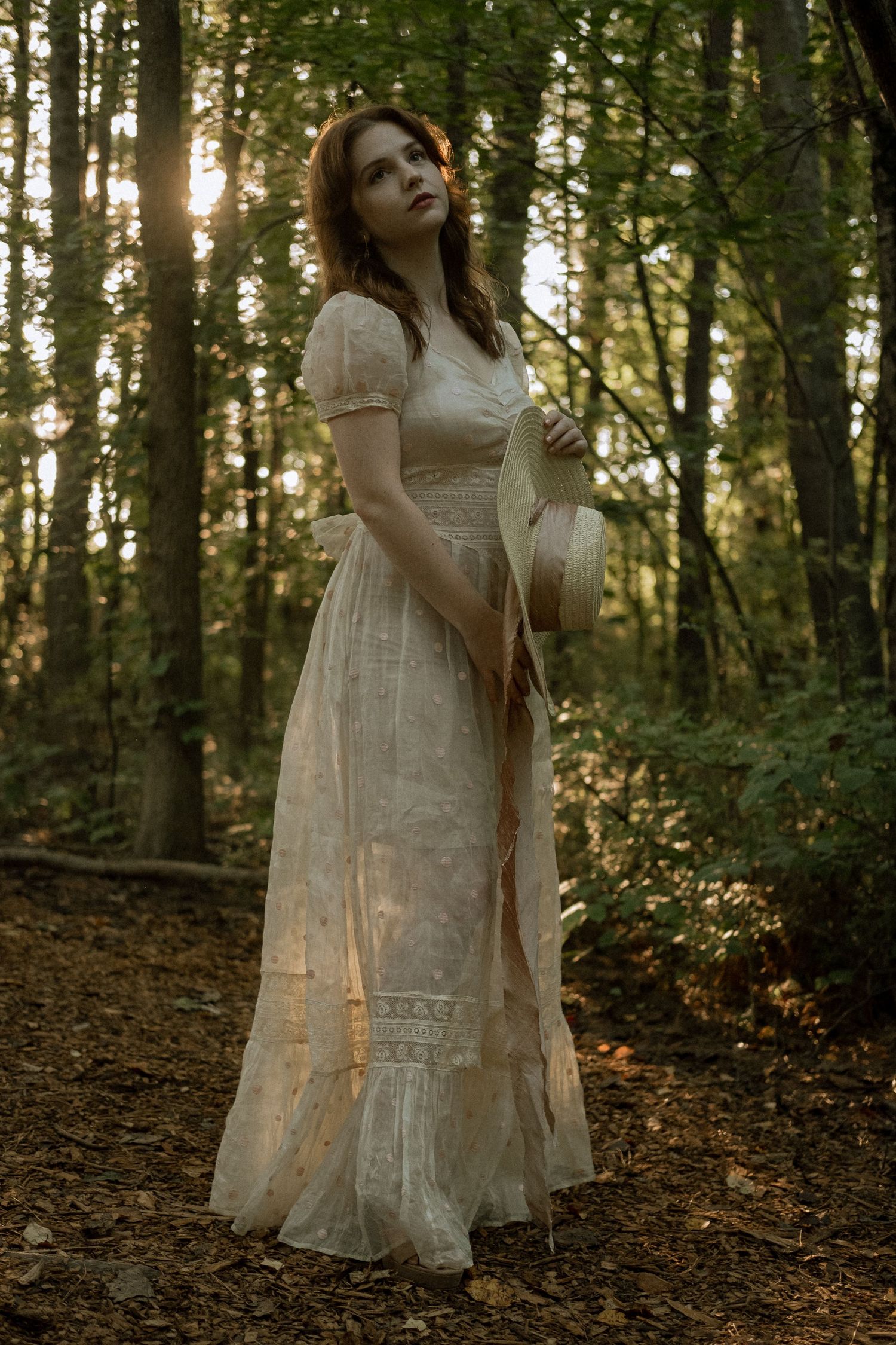 Photo of two girls in a forest wearing a vintage dress