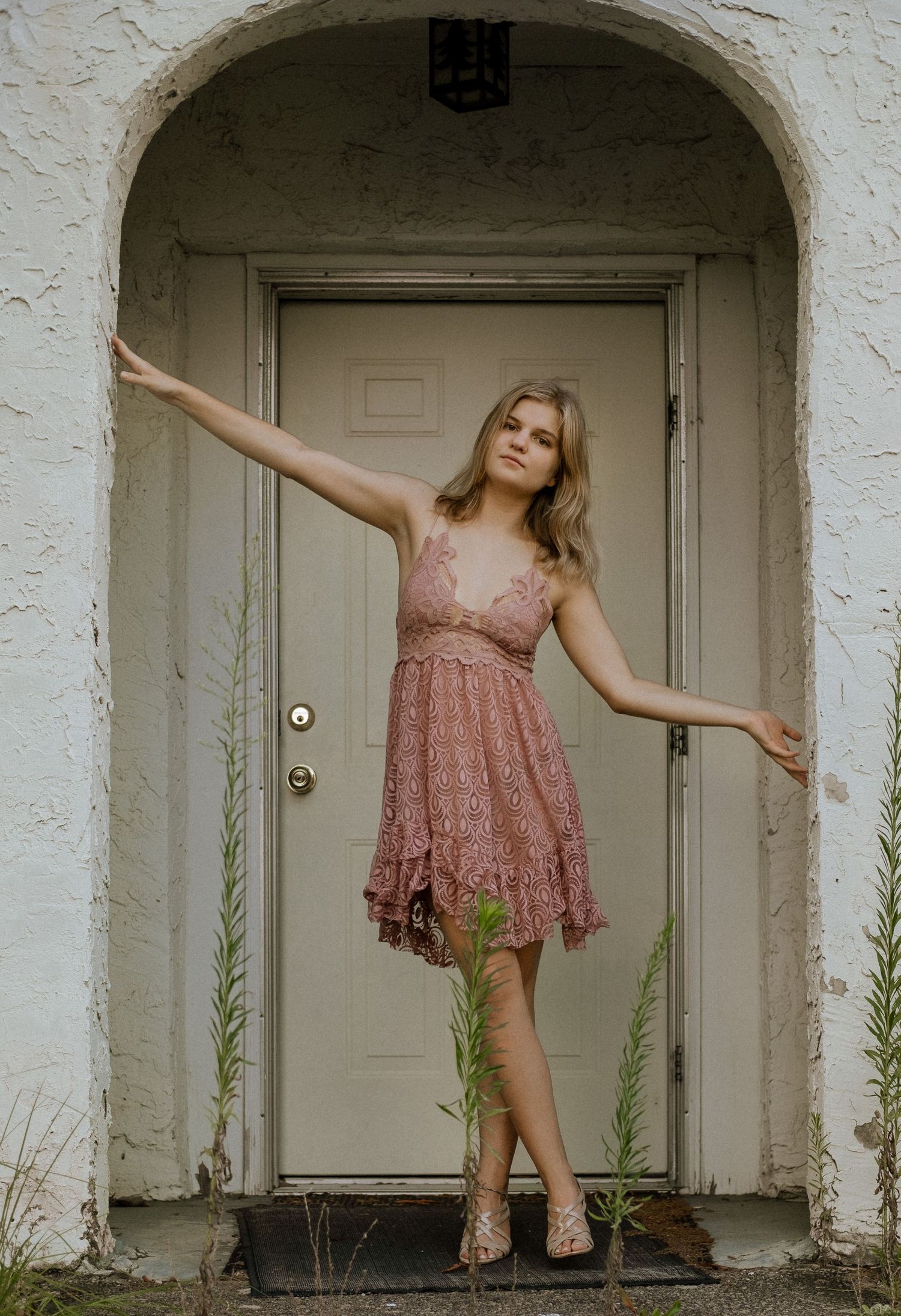 Photo of a girl against in the doorway of an abandoned building