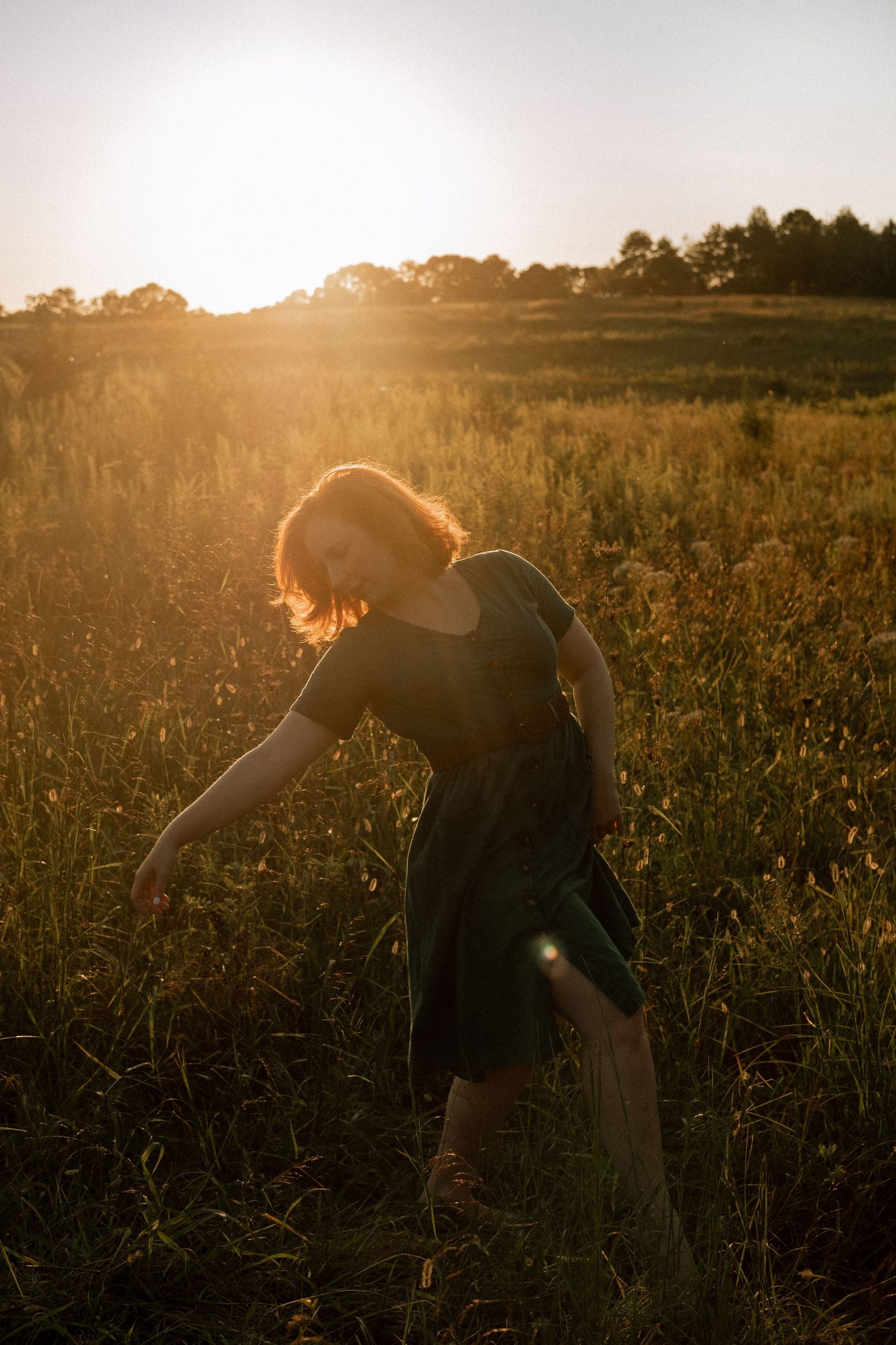 Photo of two girls in a field wearing a vintage dress at golden hour