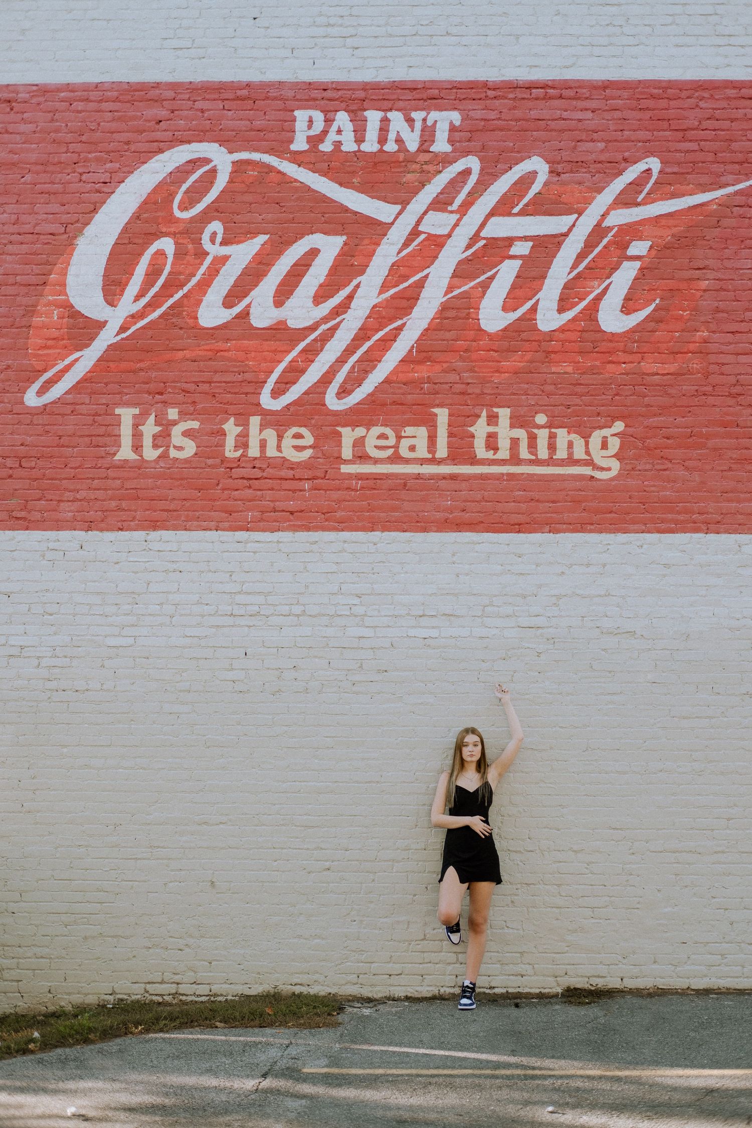 Photo of a high school senior in Atlanta with a mural
