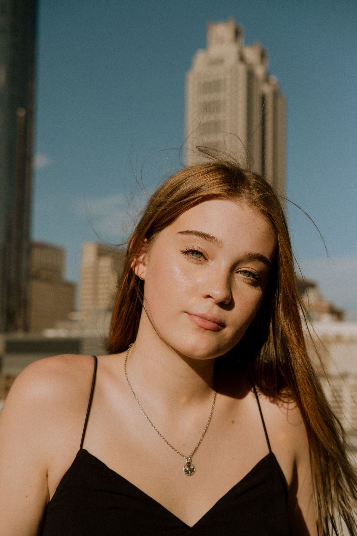 Photo of a high school senior with the Atlanta skyline