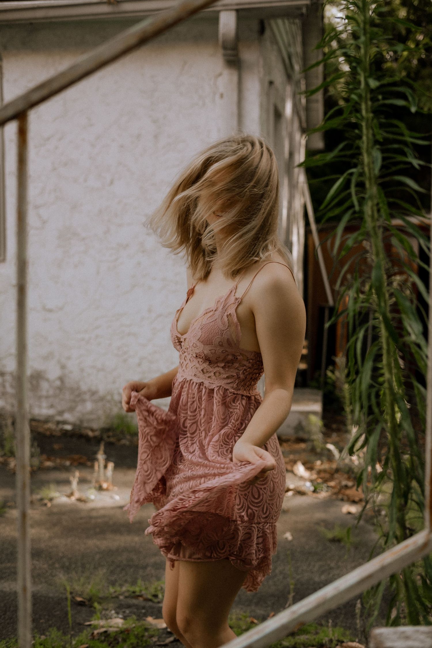 Photo of a girl dancing in front of an abandoned building