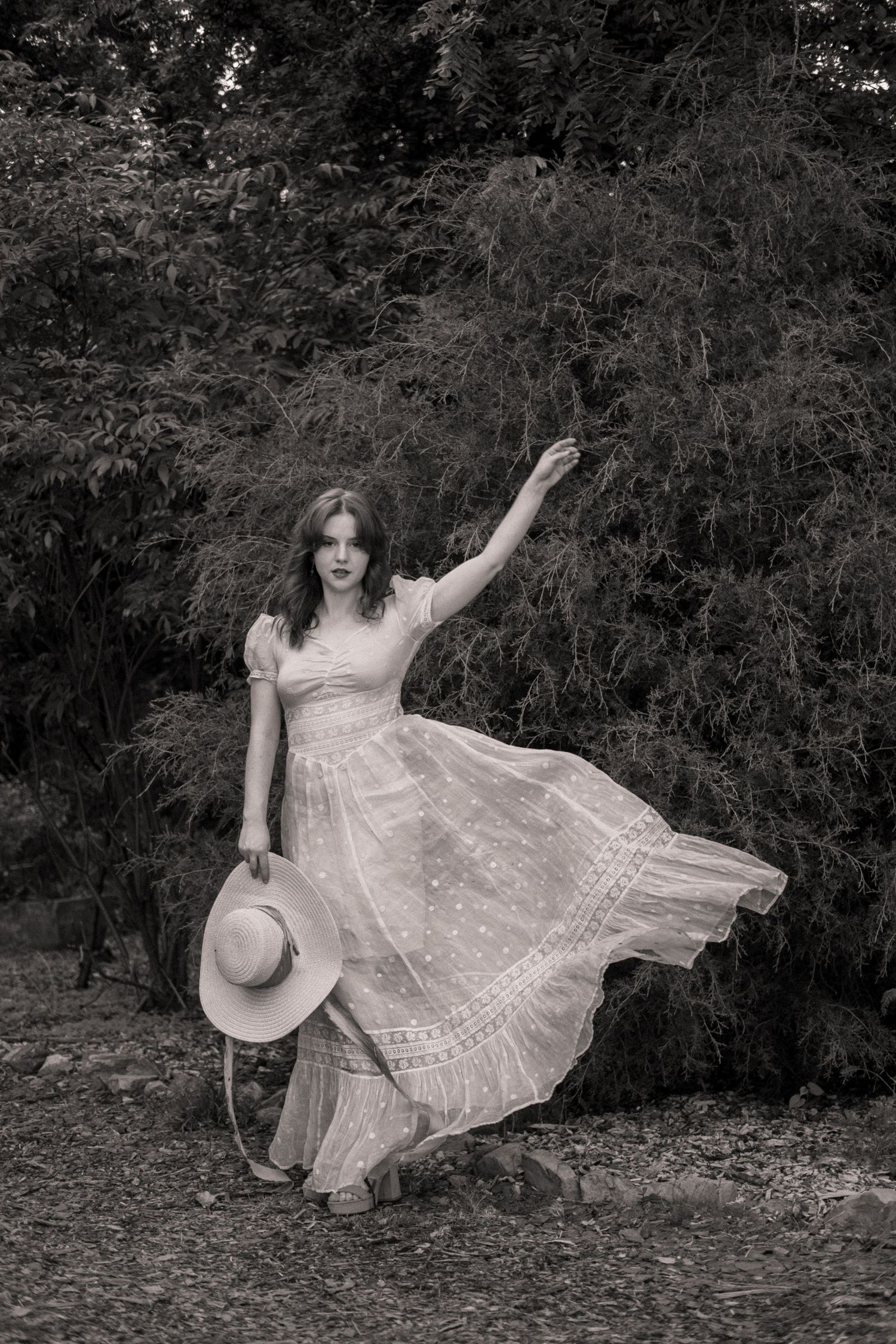 Photo of a girl in a garden wearing a vintage dress
