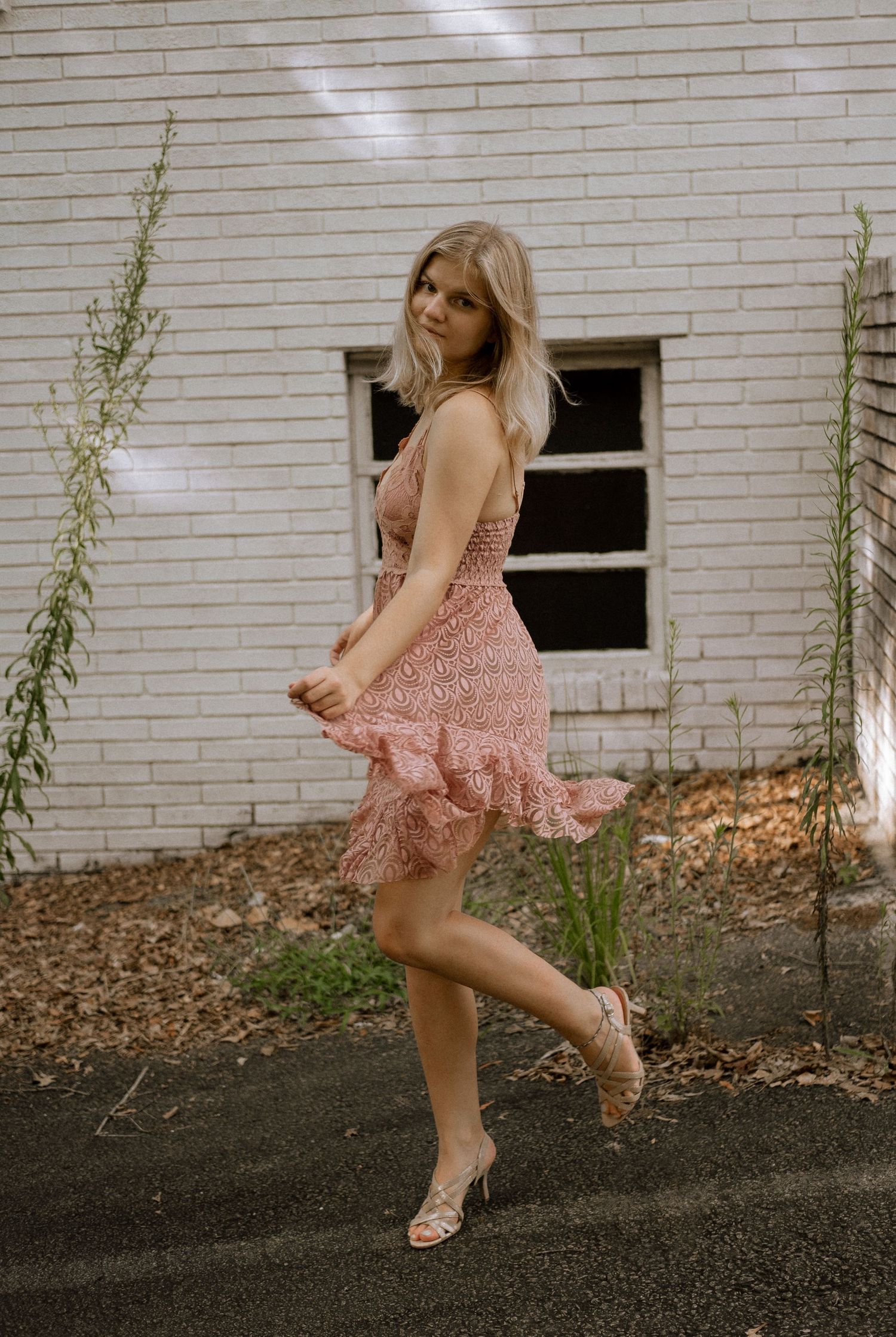 Photo of a girl dancing in front of an abandoned building