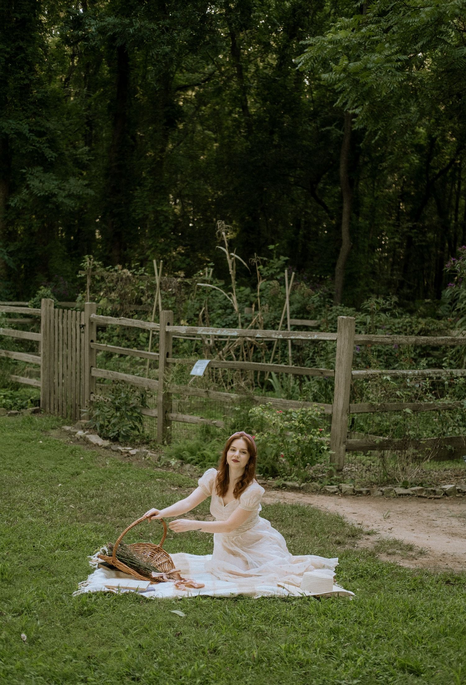 Photo of a girl in a garden wearing a vintage dress