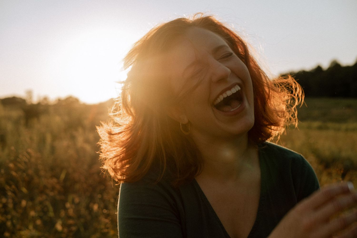 Photo of a girl in a field laughing