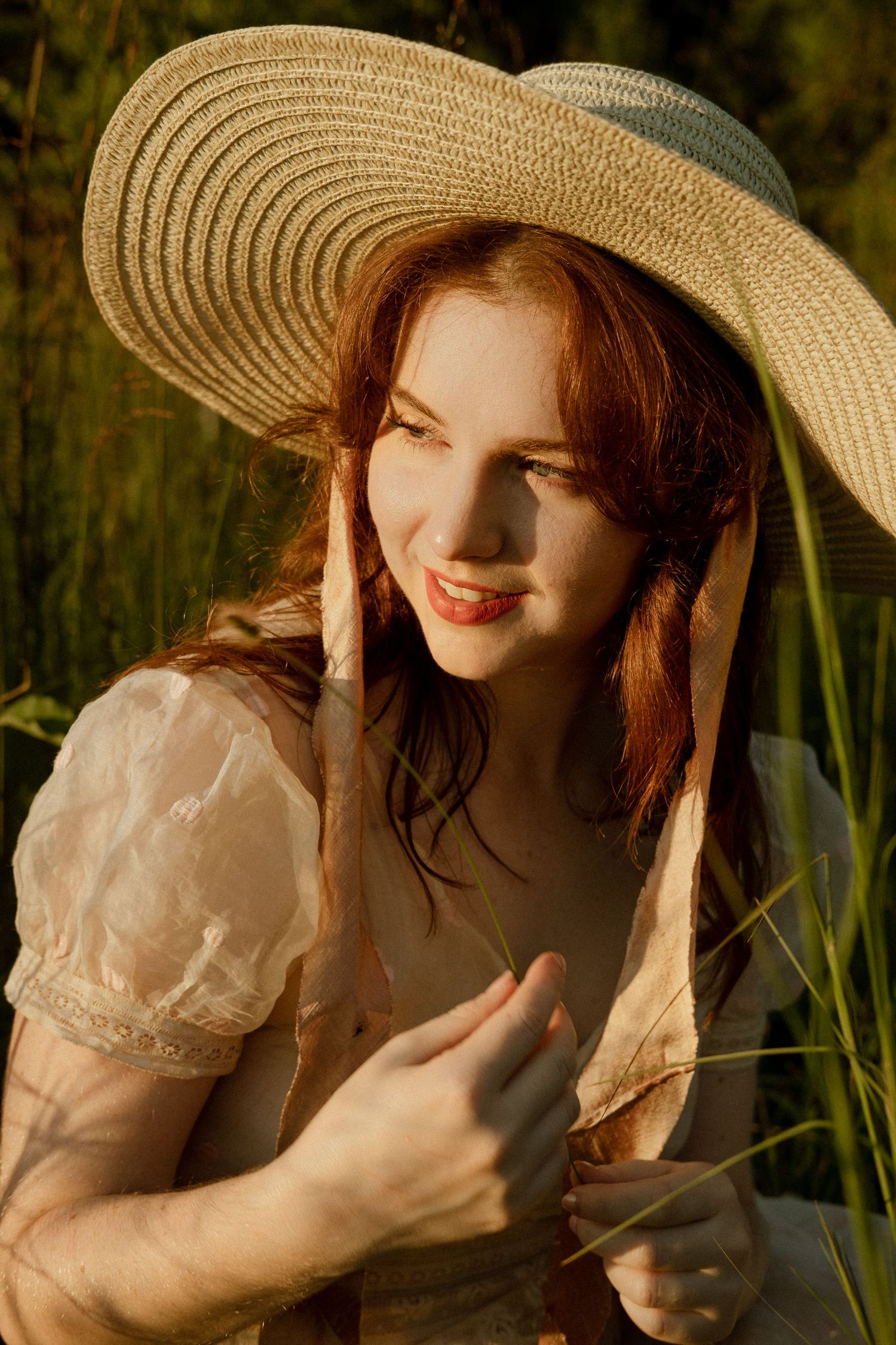 Photo of two girls in a field wearing a vintage dress at golden hour