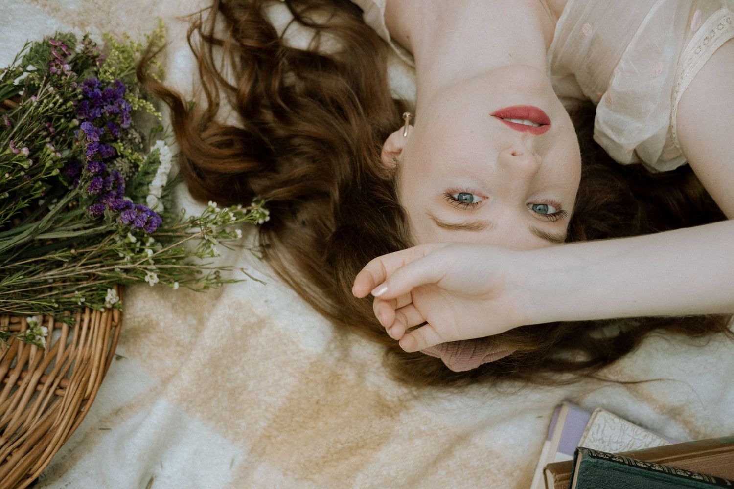 Photo of a girl in a garden wearing a vintage dress