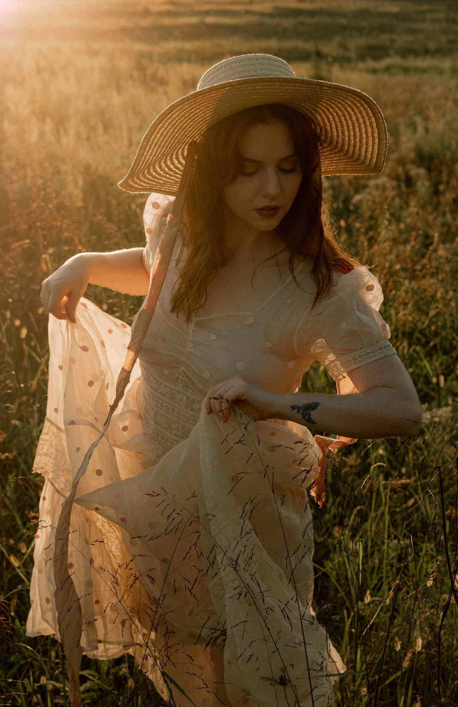 Photo of two girls in a field wearing a vintage dress at golden hour