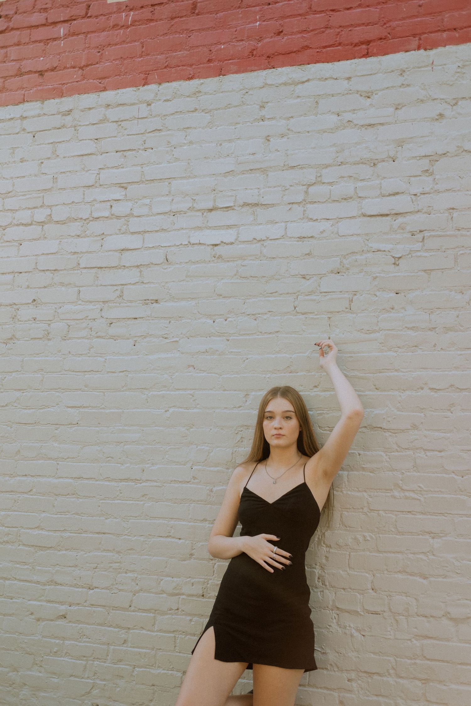Photo of a high school senior in Atlanta against a white brick wall