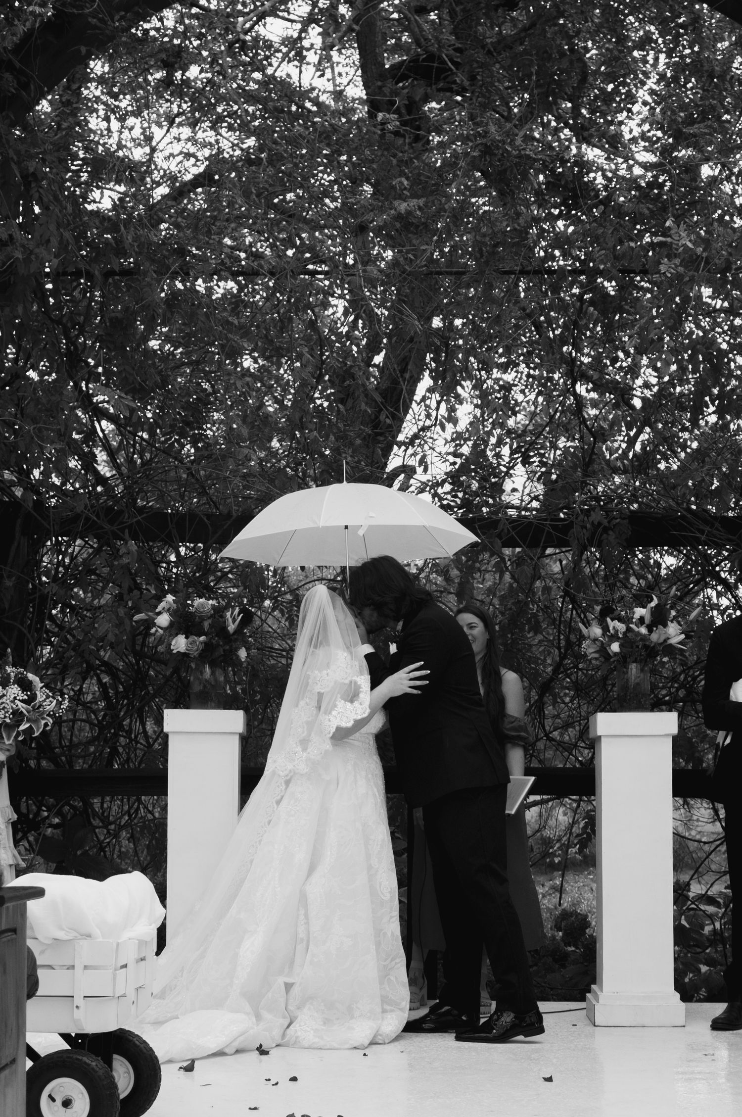 Panoramic sequence of outdoor wedding ceremony with white pillars and umbrella.