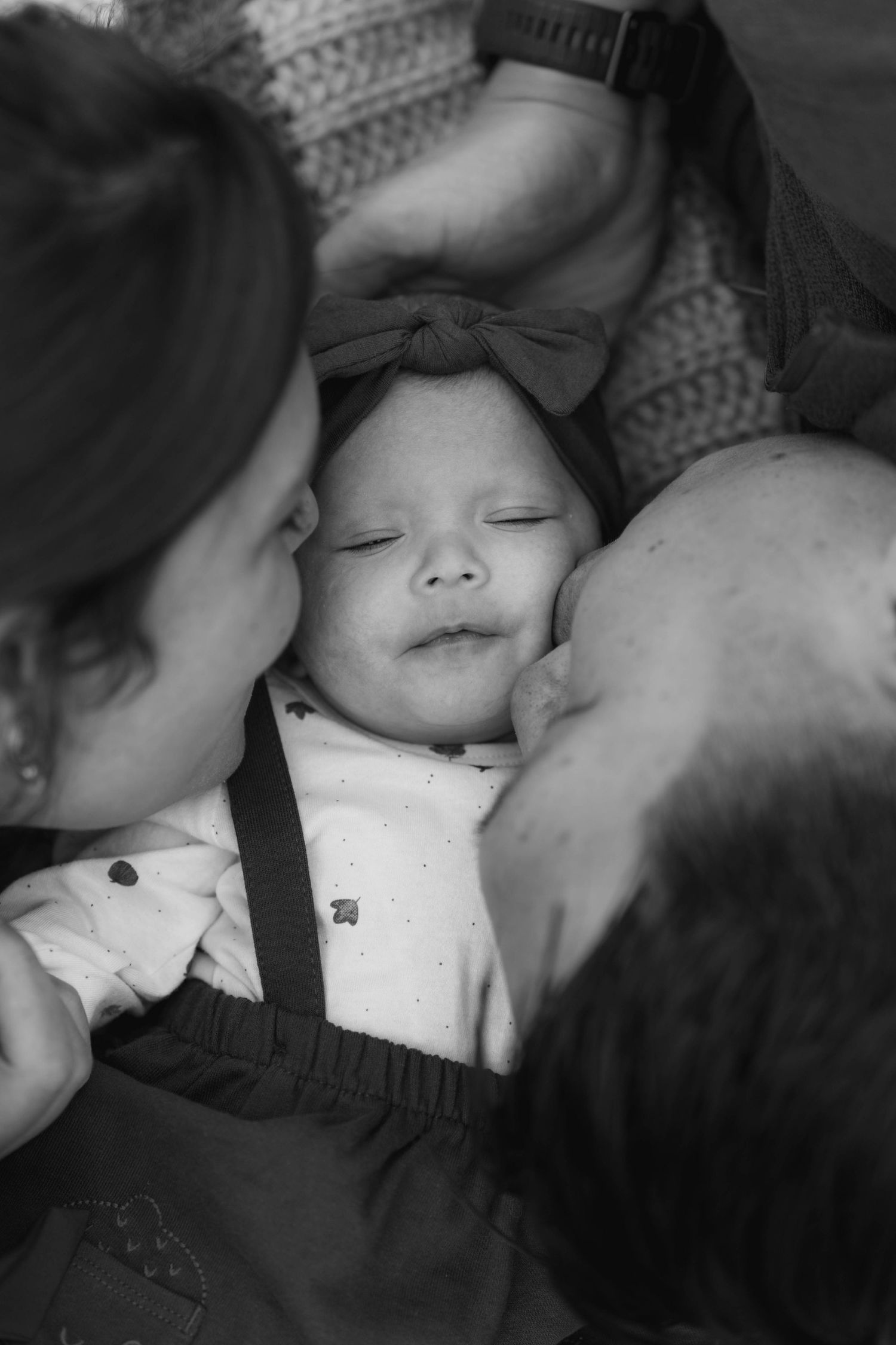 A tender black and white photo sequence showing a gentle kiss between two people.