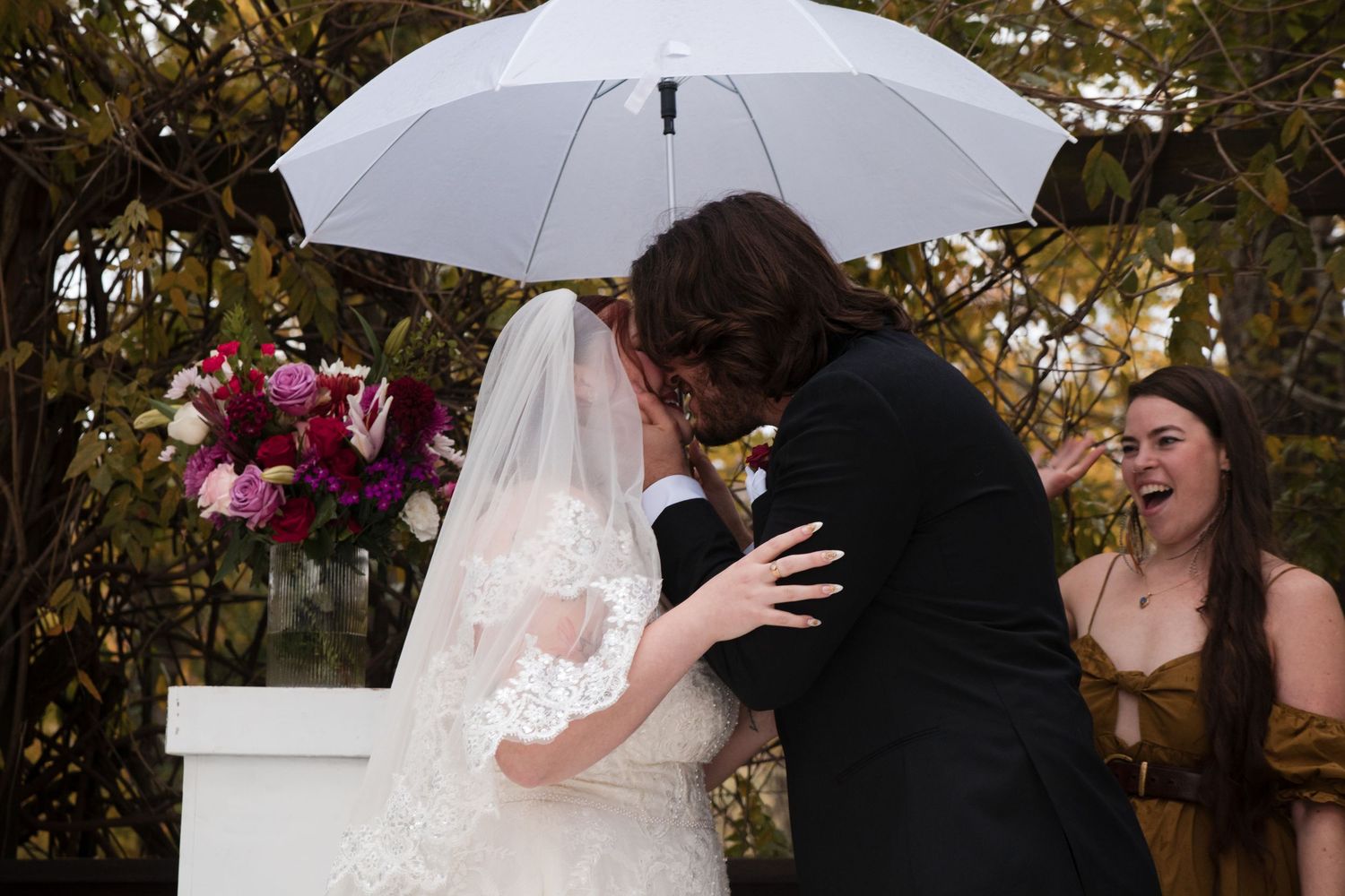 A series of candid wedding moments showing the bride and groom embracing during their outdoor ceremony.