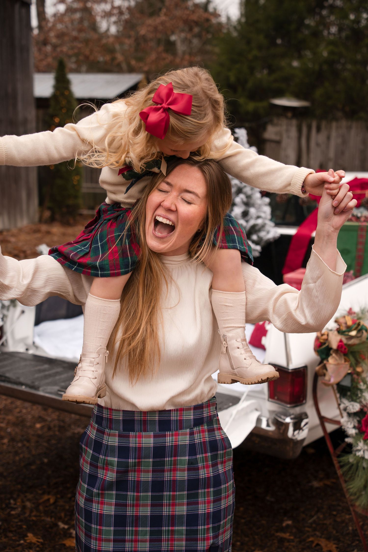 A sequence of four photos showing someone in a plaid skirt and cream sweater dancing joyfully outdoors.