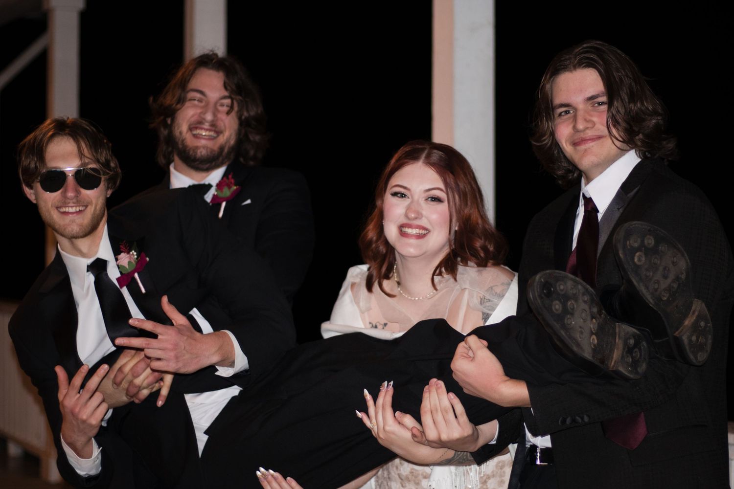 People in formal attire dance and celebrate at what appears to be an elegant party or reception.