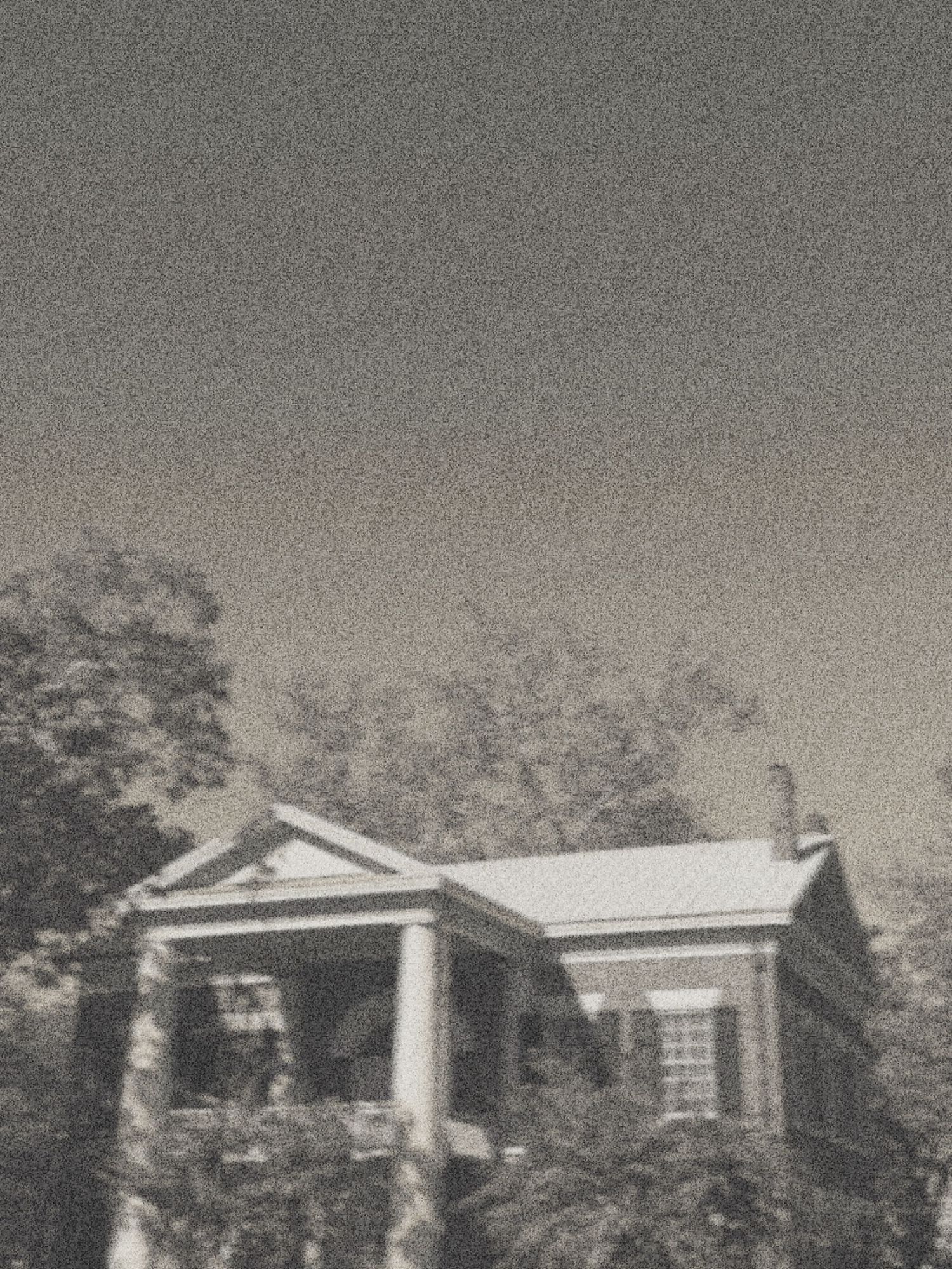 Black and white photograph showing a series of small suburban ranch-style houses with similar architectural designs.