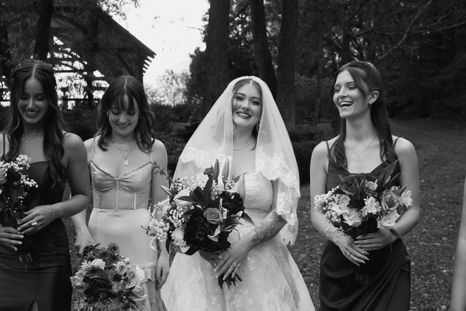 A series of black and white wedding photos showing candid moments and celebrations outdoors.
