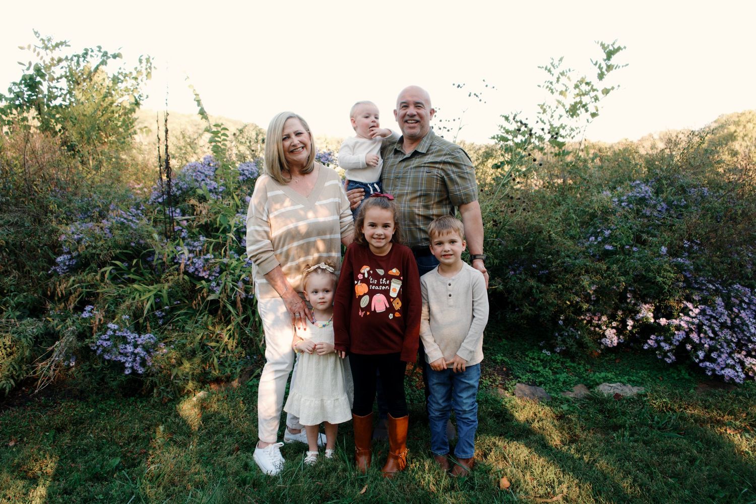 A series of outdoor family portrait photographs taken in a garden setting during golden hour lighting.