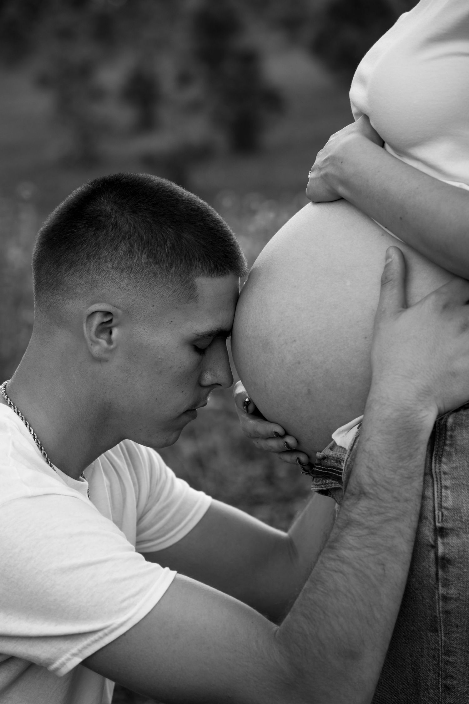 A series of intimate black and white photos showing a couple embracing in a romantic moment.