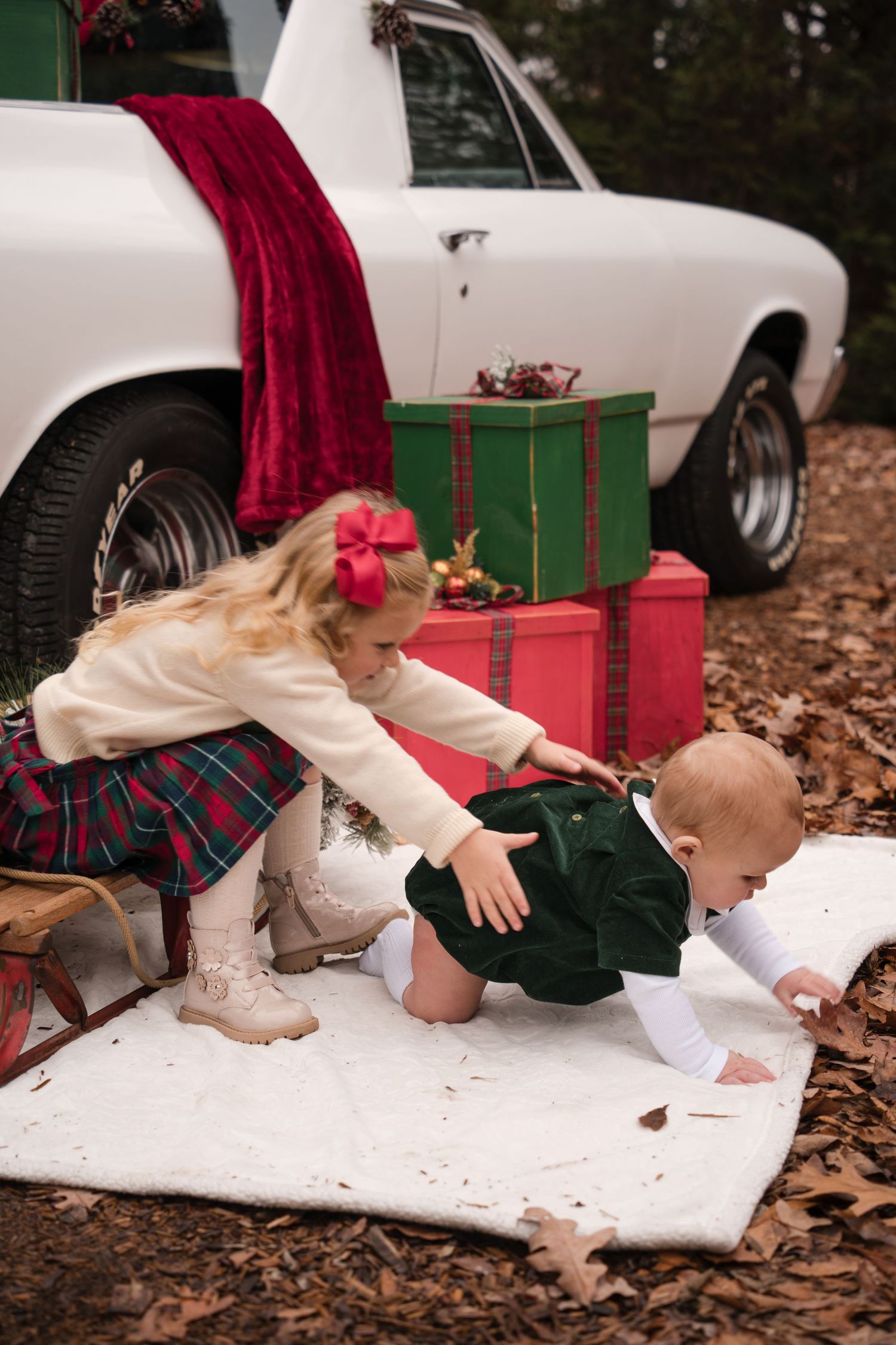 A series of photos showing a baby crawling on a white blanket near a car surrounded by autumn leaves.