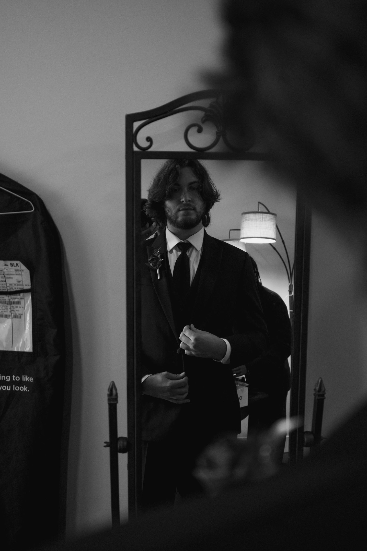Black and white photos of groomsmen getting ready in formal attire.