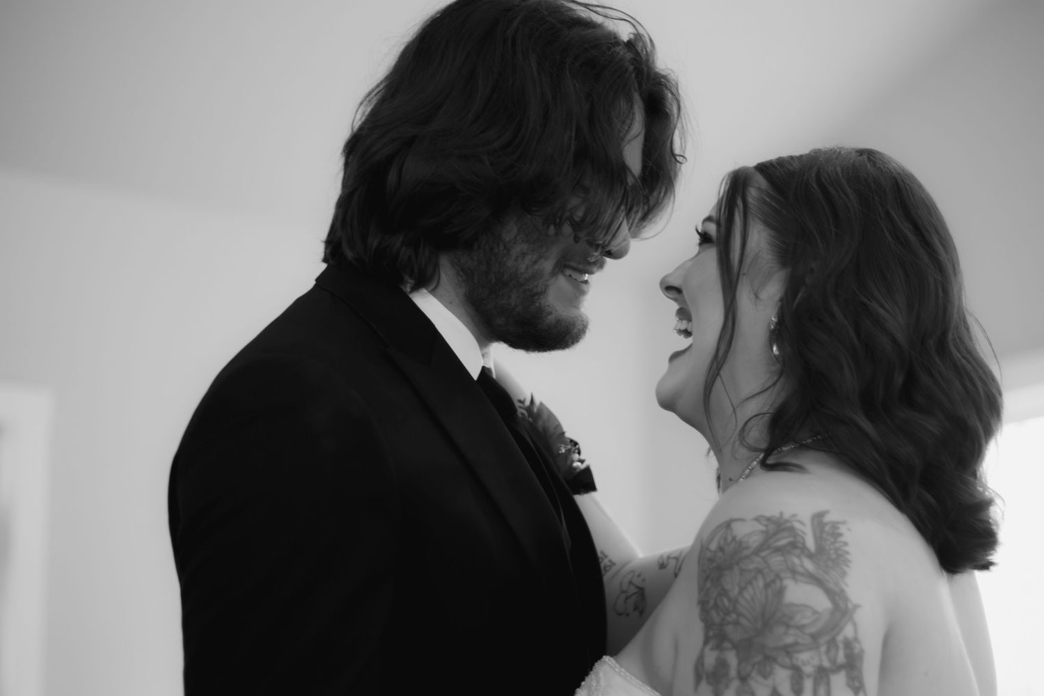 Black and white wedding photo collage showing romantic moments between a couple in formal attire.