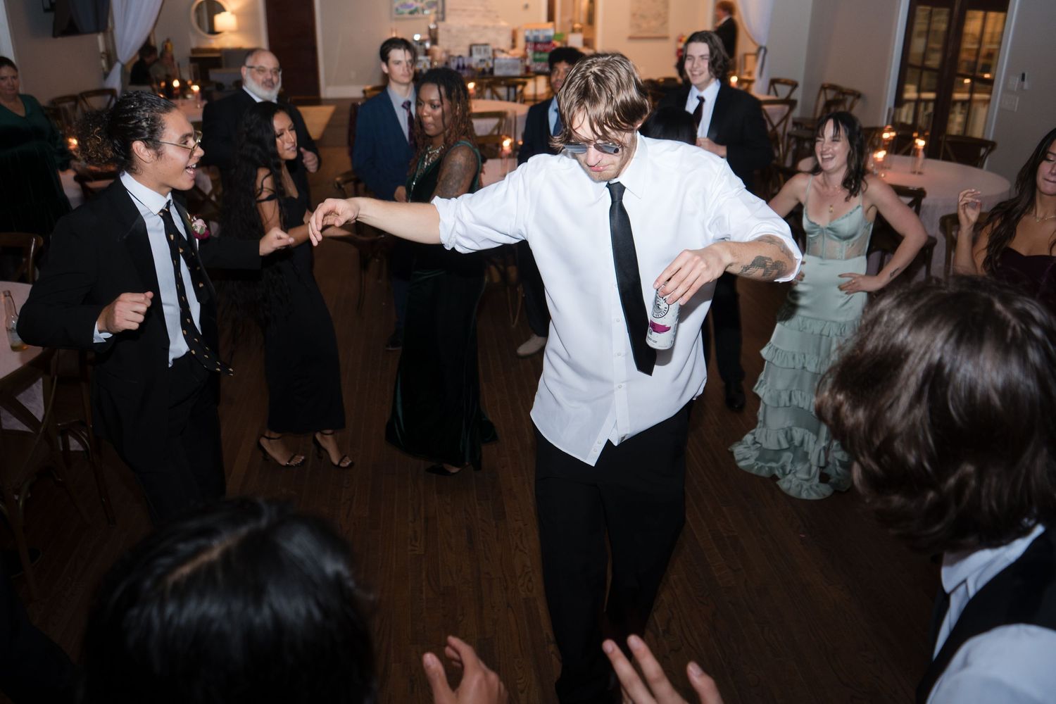 Wedding reception dance floor filled with guests enjoying the celebration.