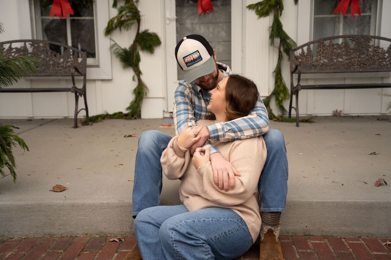 A sequence of images showing a couple sitting on a bench in an outdoor setting sharing intimate moments together.
