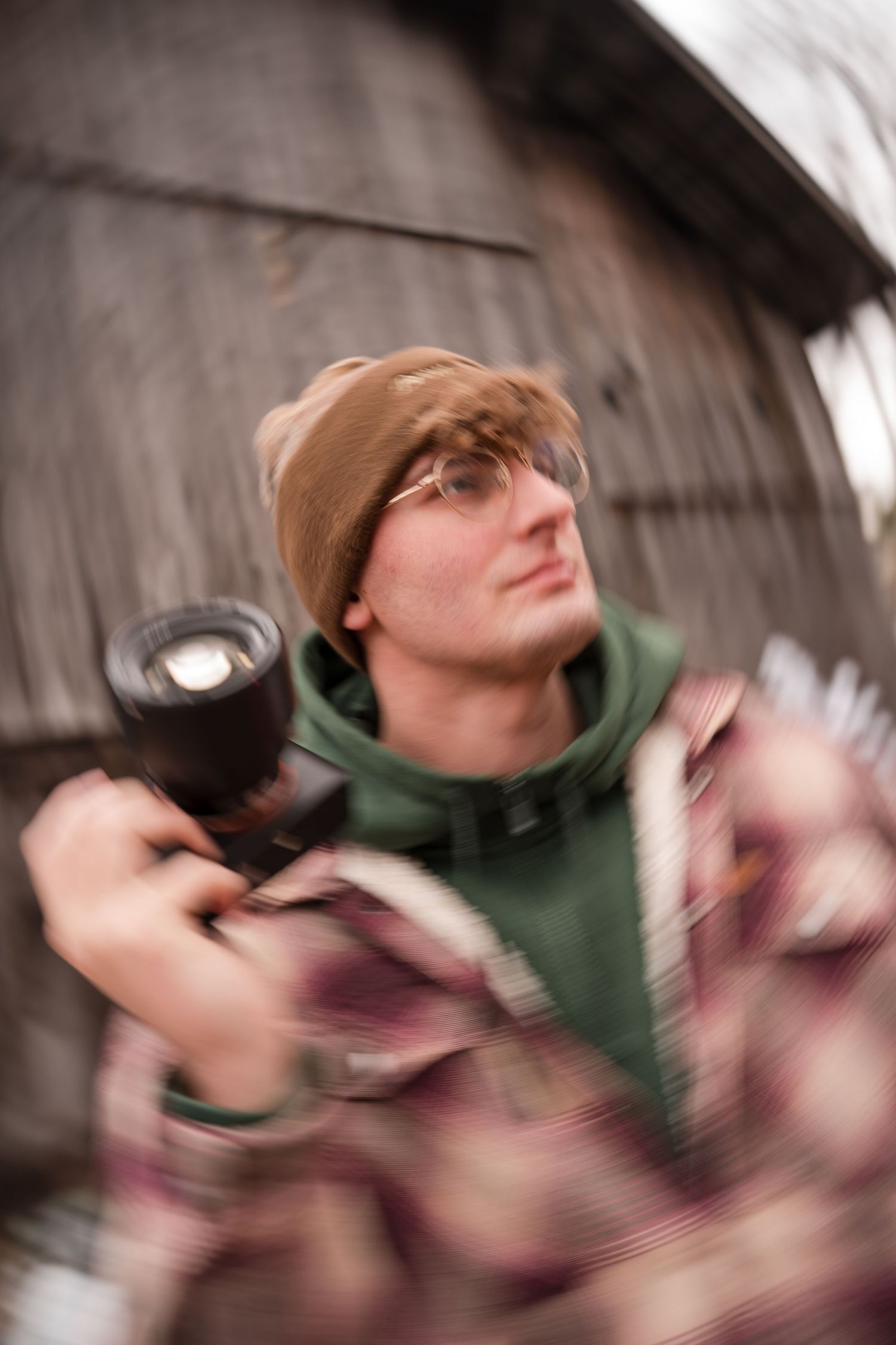 A sequence of motion blur photos shows someone in a green shirt spinning and moving dynamically against a dark background.