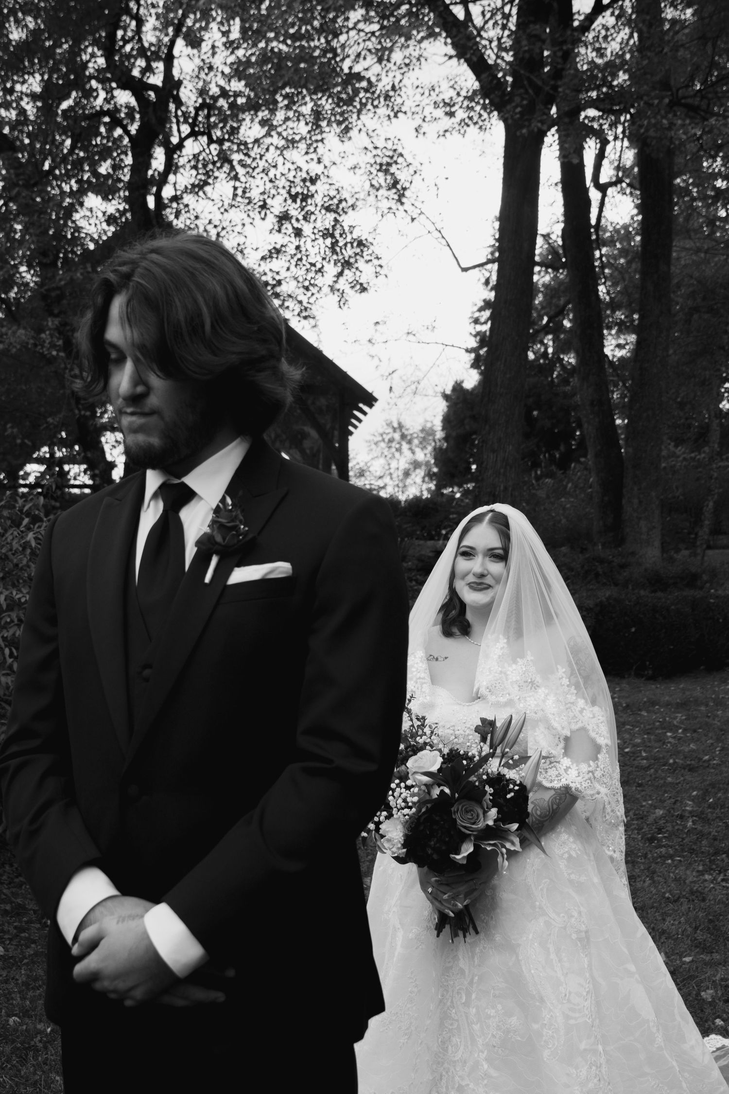 Black and white wedding photos showing a couple in traditional attire with bride in white dress and veil outdoors.