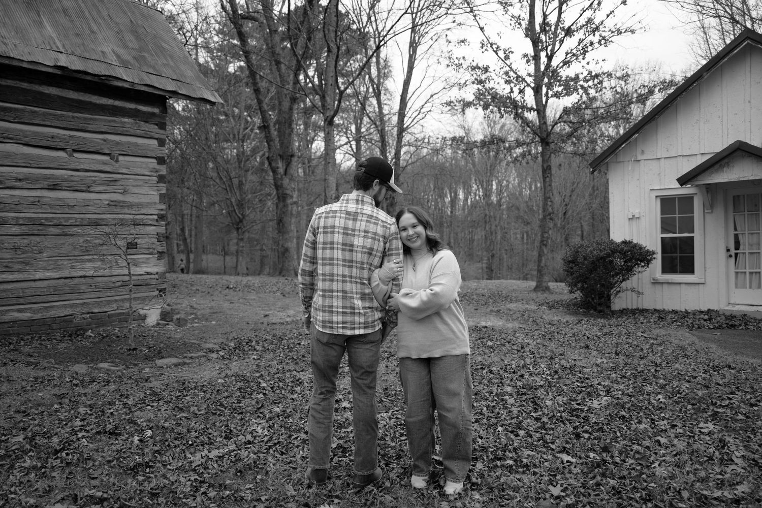 A series of black and white photographs showing people walking and spending time together outdoors near rural buildings.