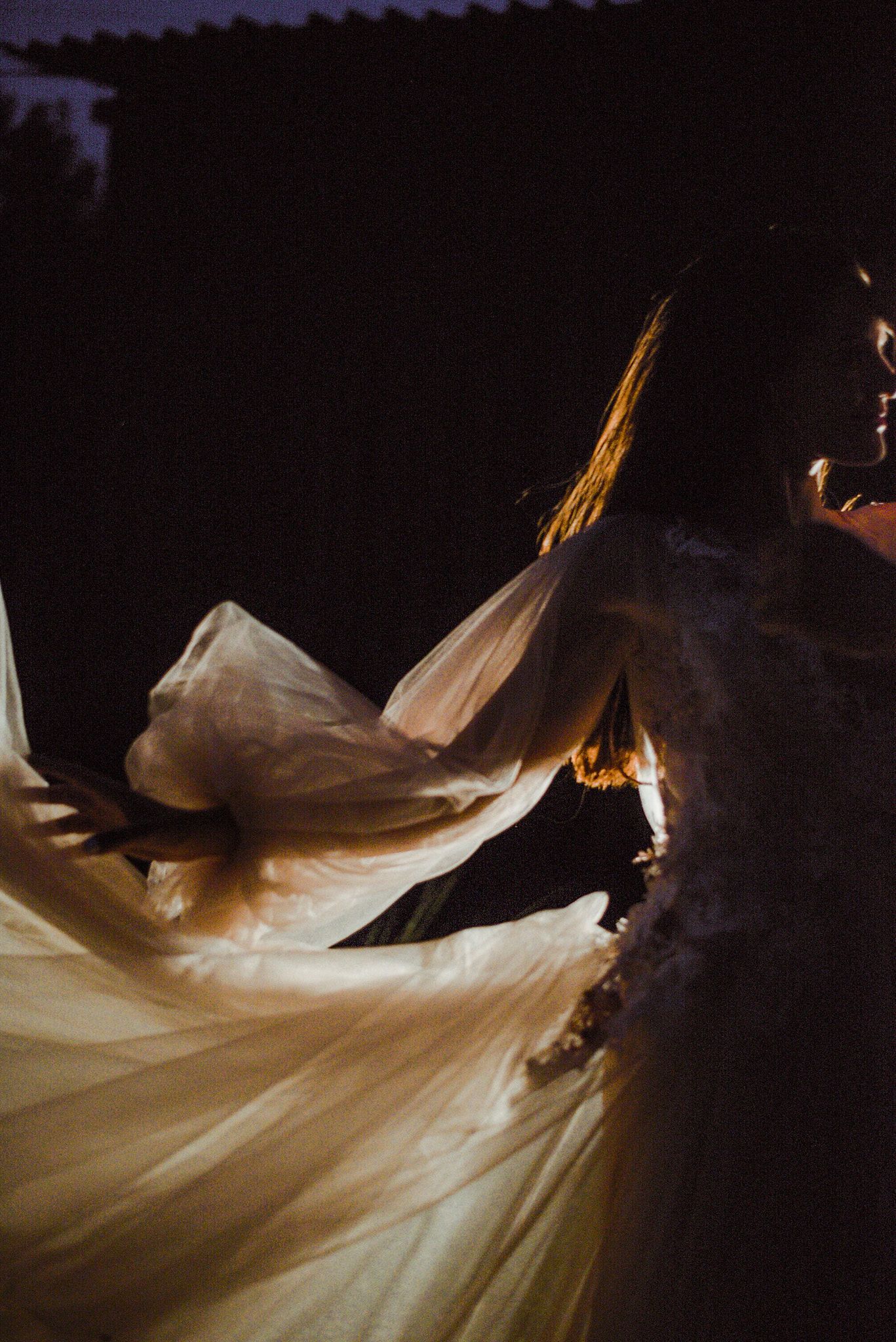 A flowing white fabric creates ethereal movement against a dark background in a series of artistic dance photographs.