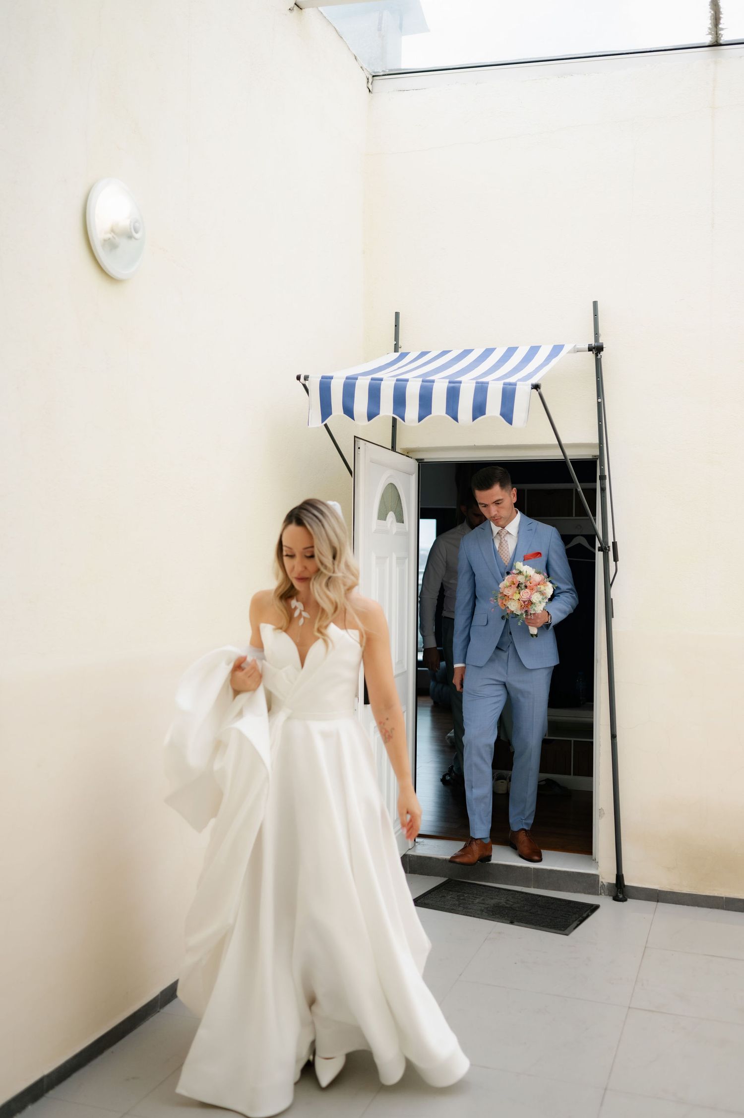 A sequence of wedding preparation photos showing a bride in a white gown and groom in a blue suit getting ready separately.
