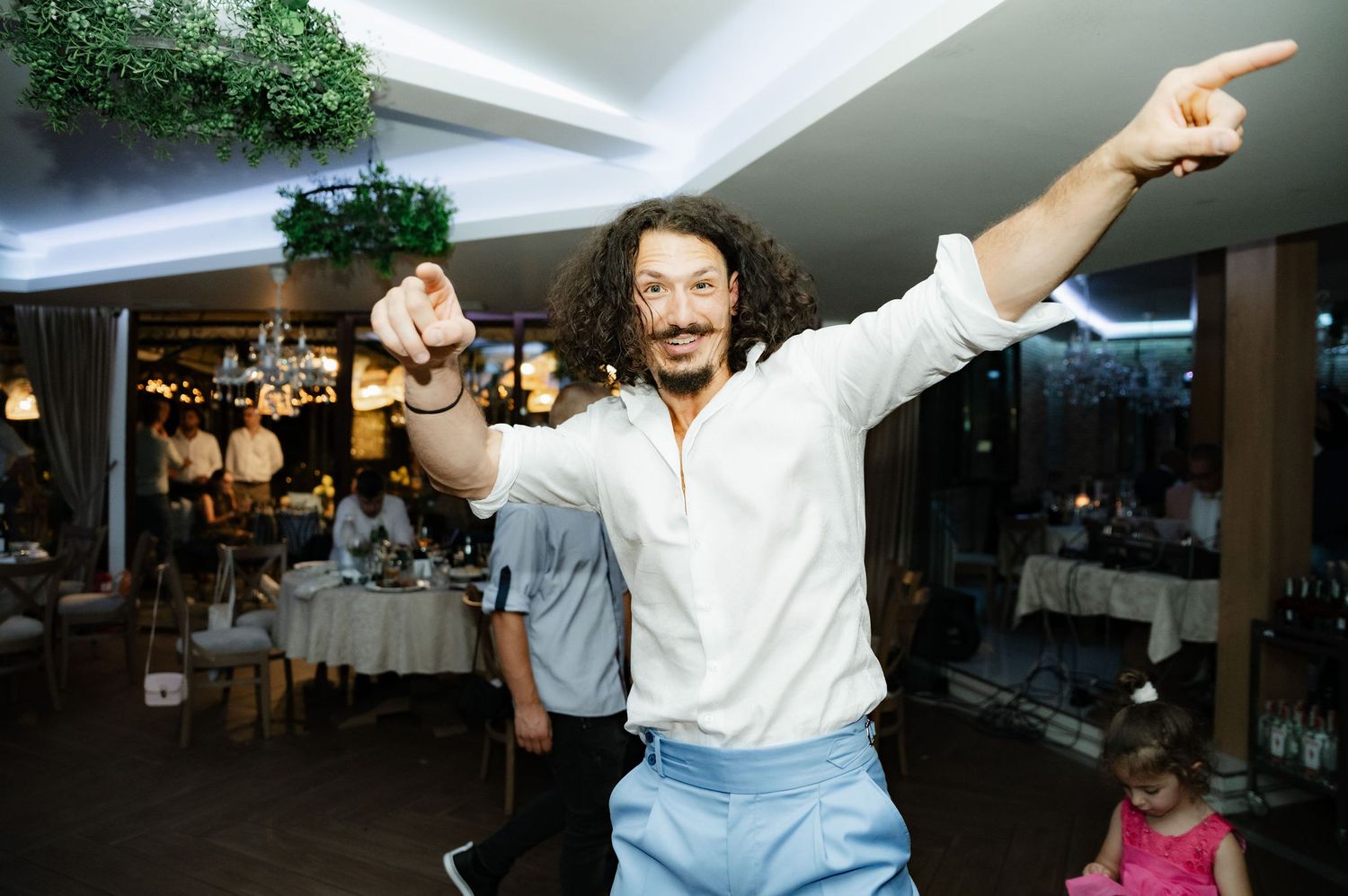 People dancing and socializing at what appears to be a lively party or celebration event.
