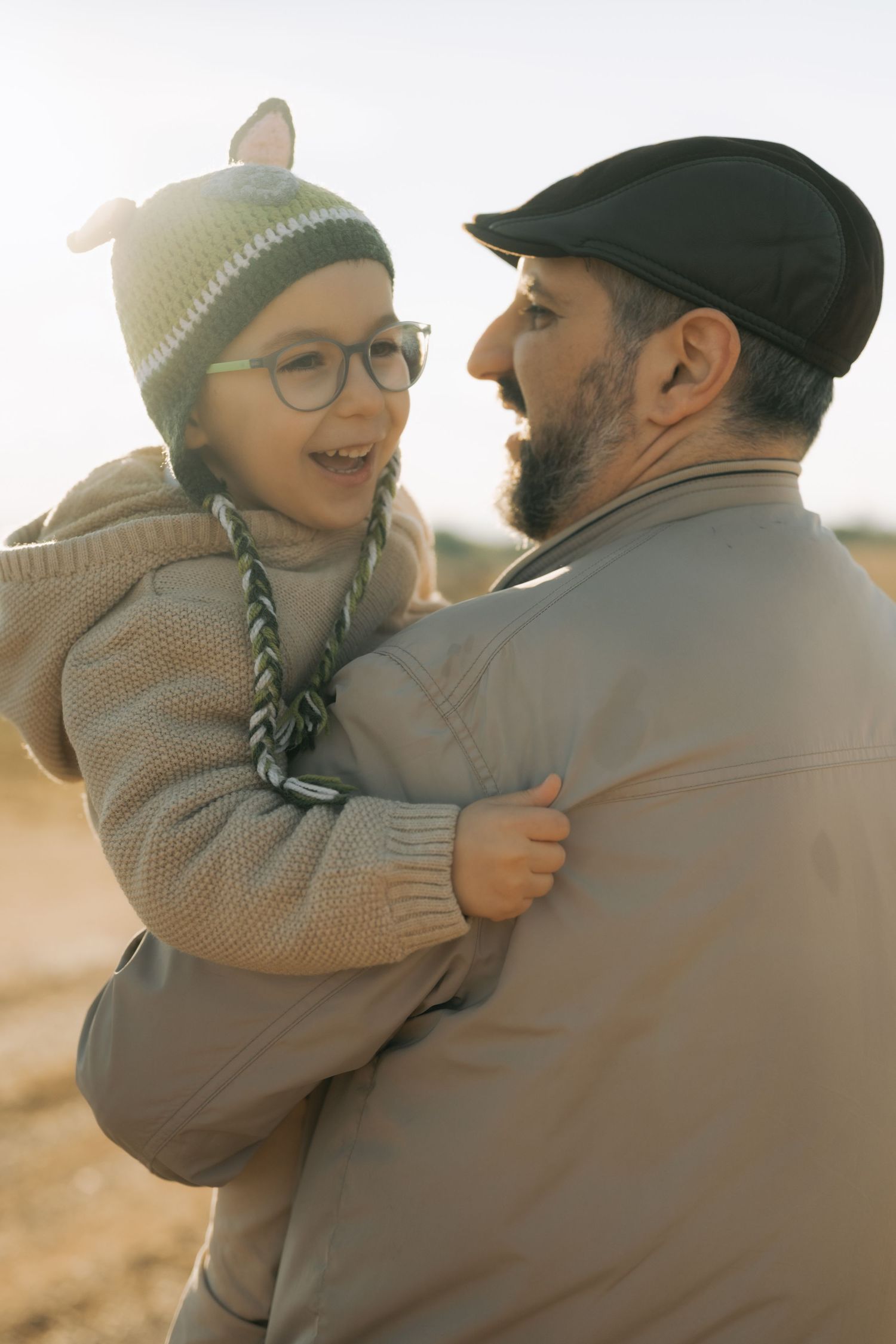 A heartwarming series of candid moments showing a parent and child embracing outdoors during golden hour.