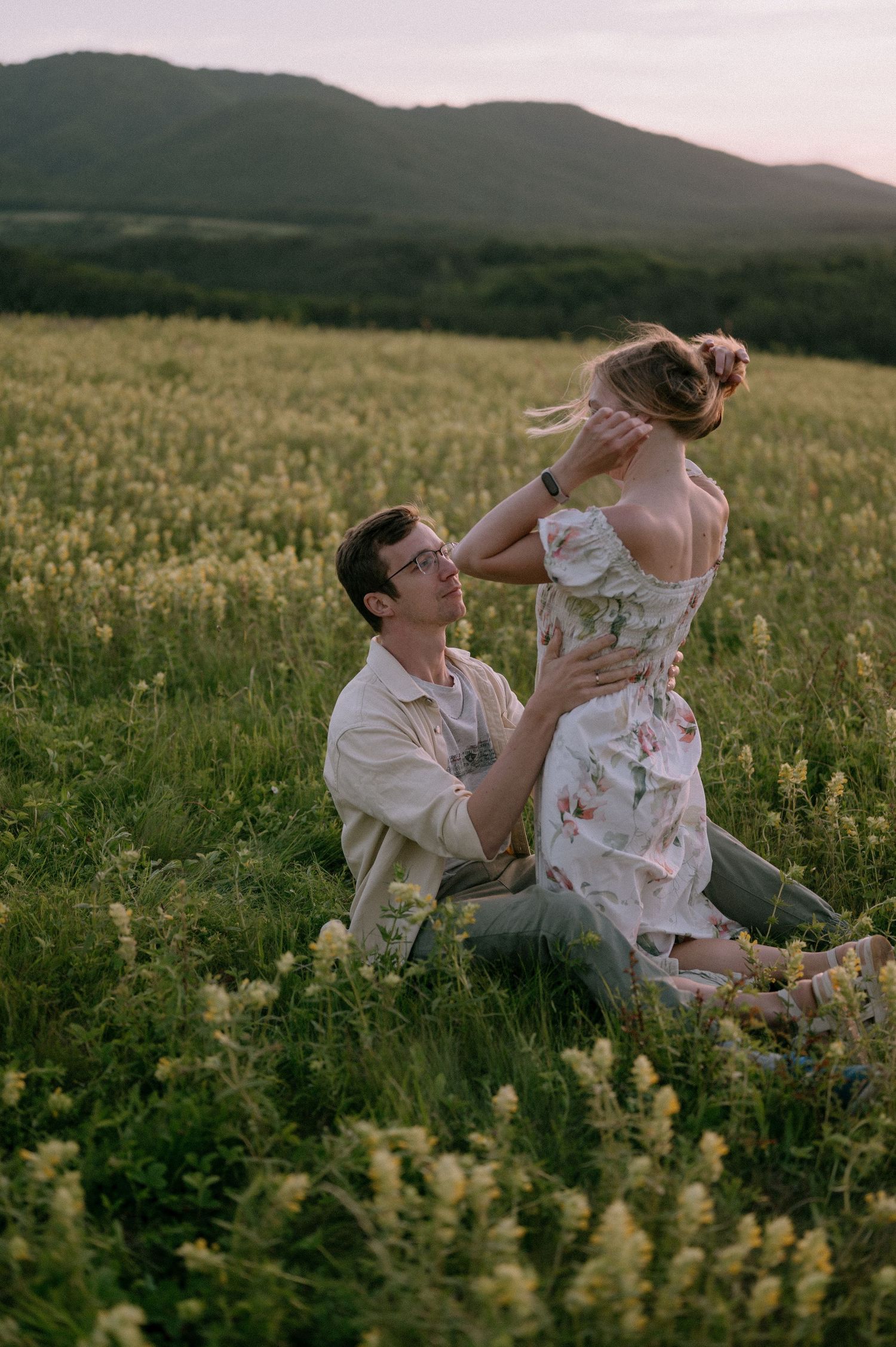 Romantic sunset moment captured in mountain wildflower field.