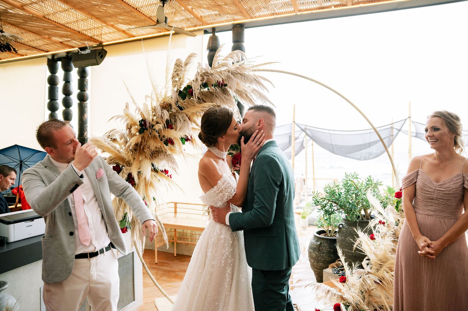 Wedding venue showcases rustic wooden ceiling and decorative black posts with natural light streaming in.