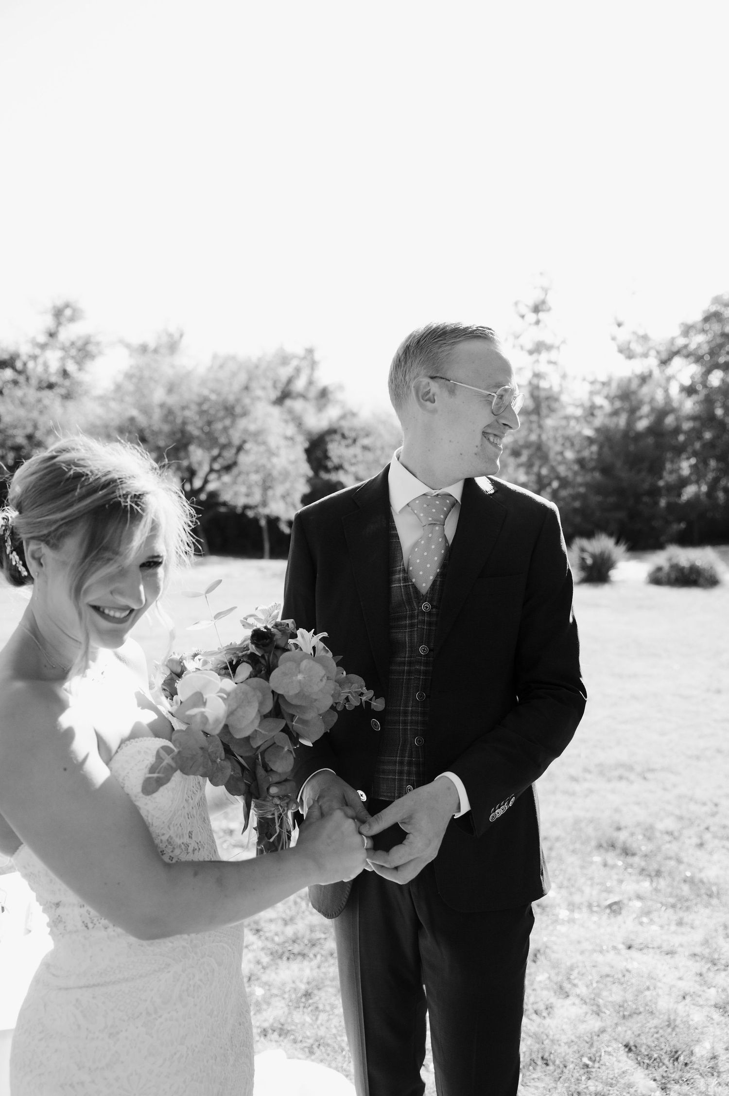 Black and white wedding photos showing couple sharing romantic moments in a garden setting.