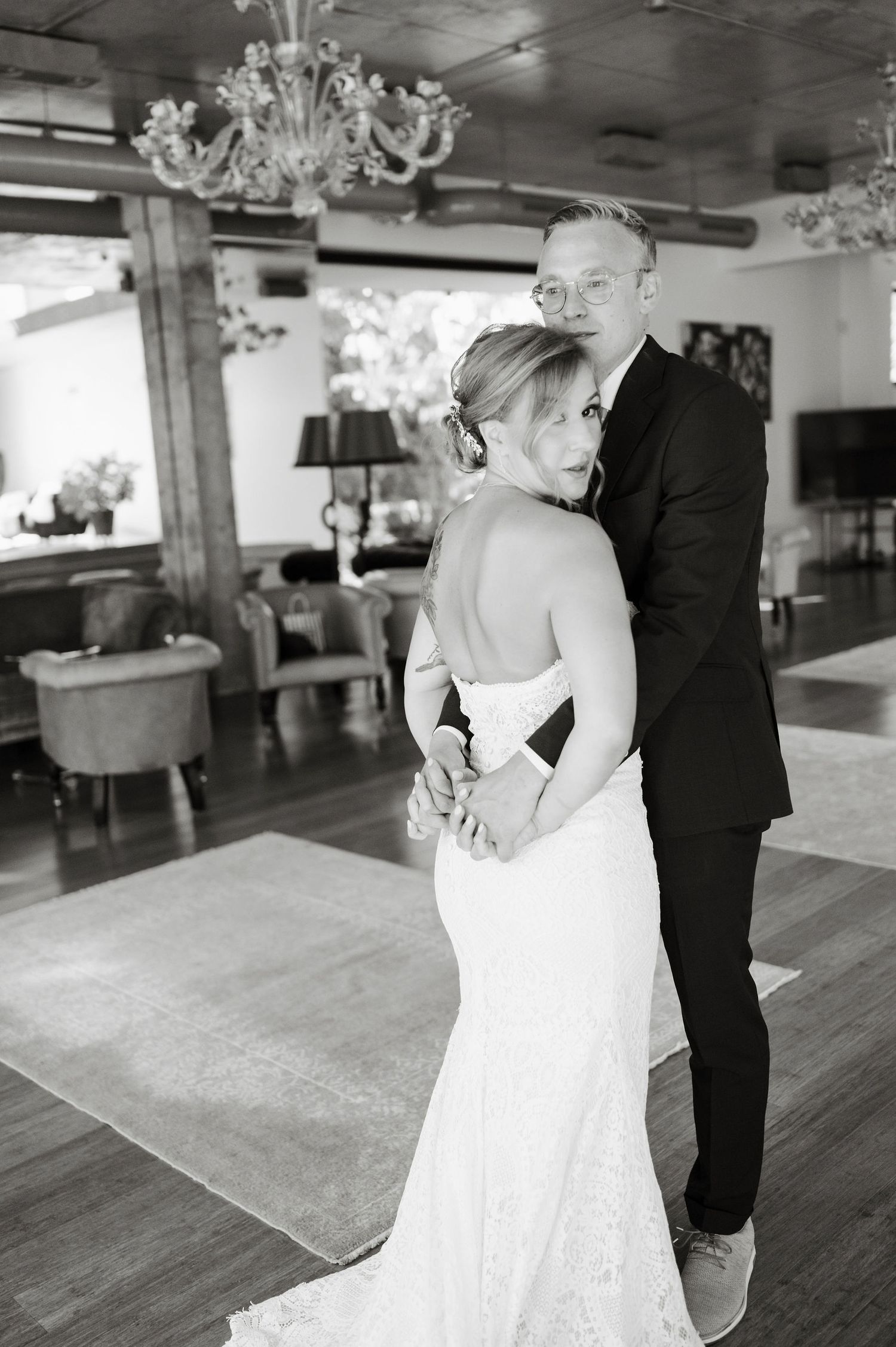 Black and white wedding photo capturing intimate first look between bride and groom.