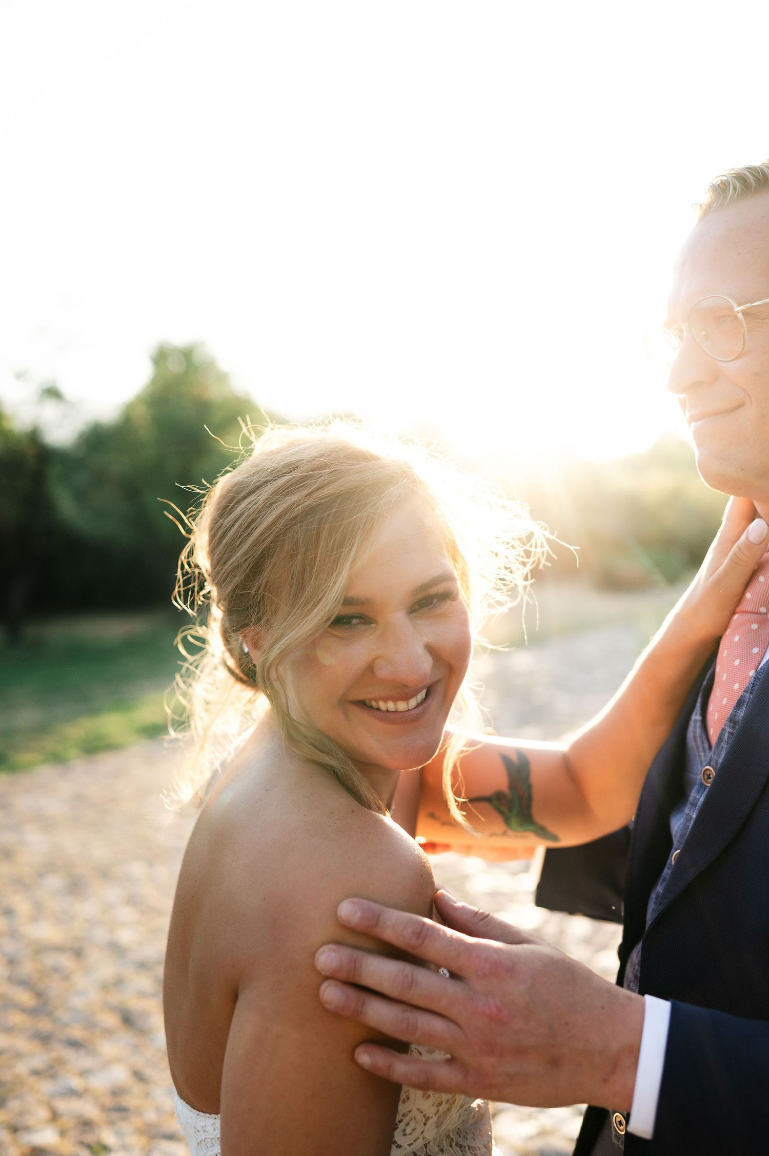 Joyful wedding portraits captured in stunning sunset lighting.