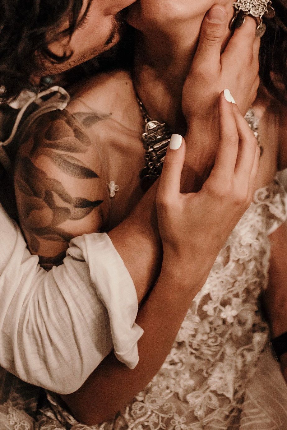 A series of romantic sepia-toned photos showing close-up intimate moments between a couple in wedding attire.