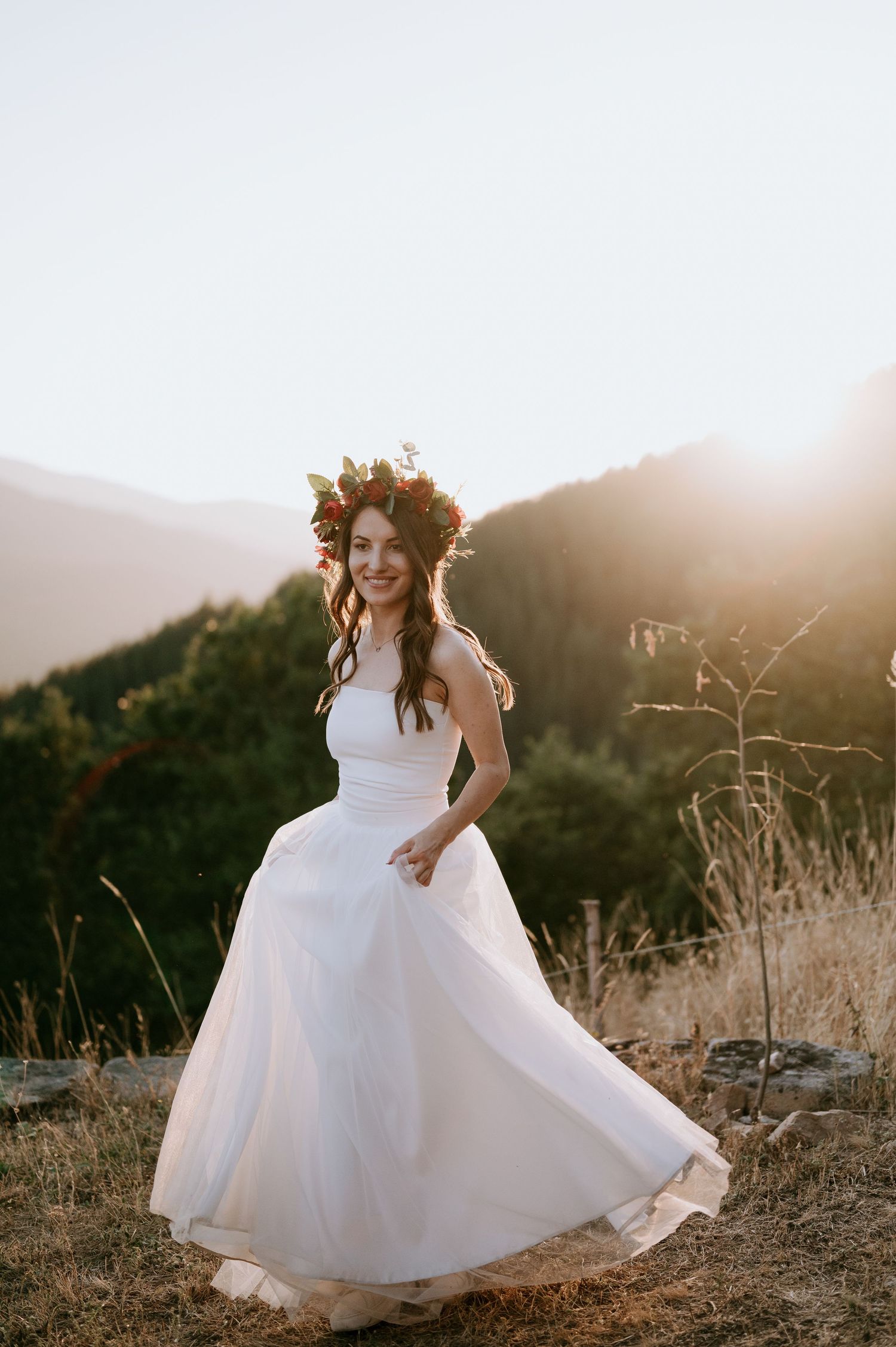 A wedding dress dances in motion against mountains and golden hour light.