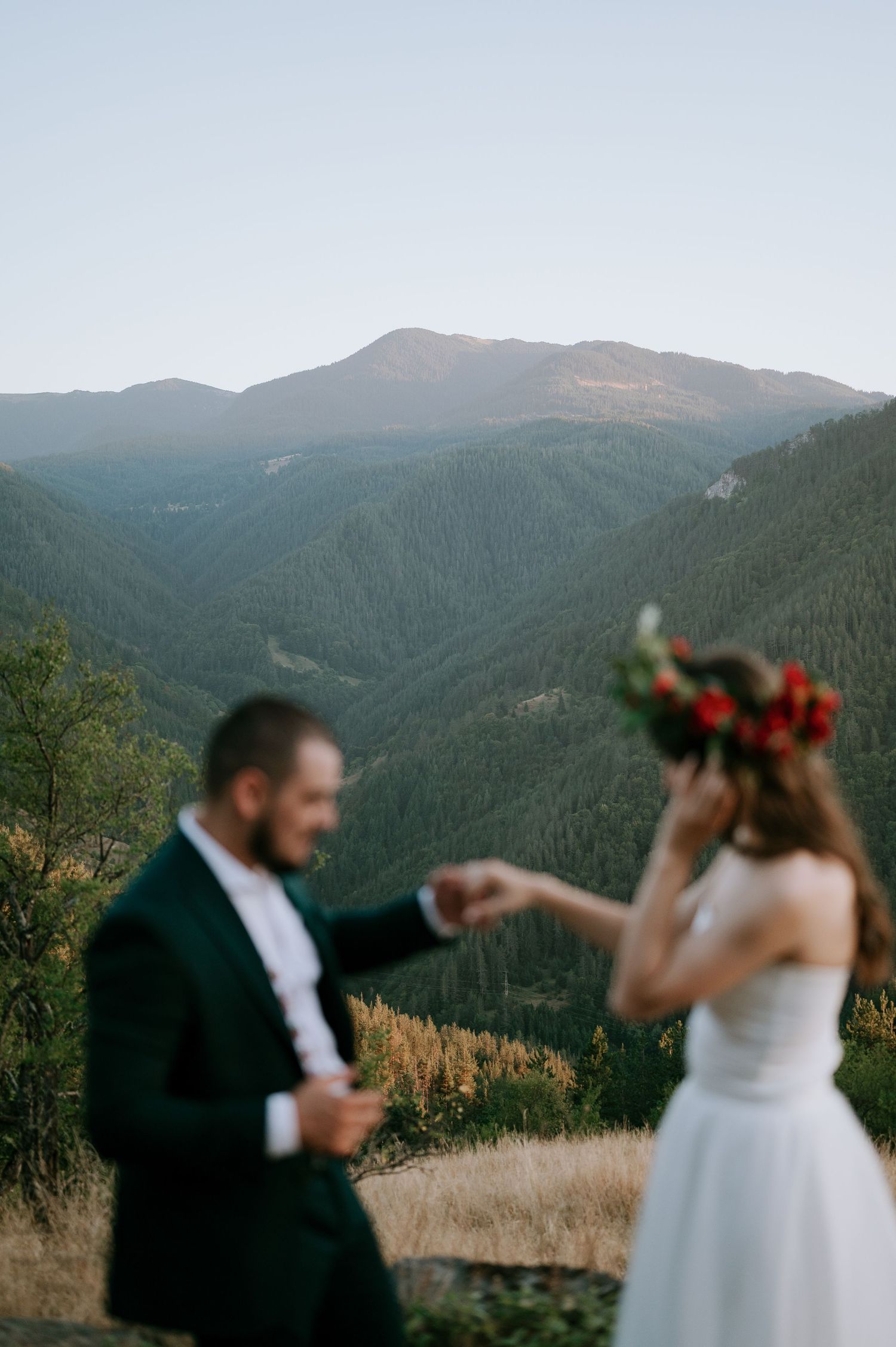 Mountain wedding photography session with dramatic landscape views in the background.