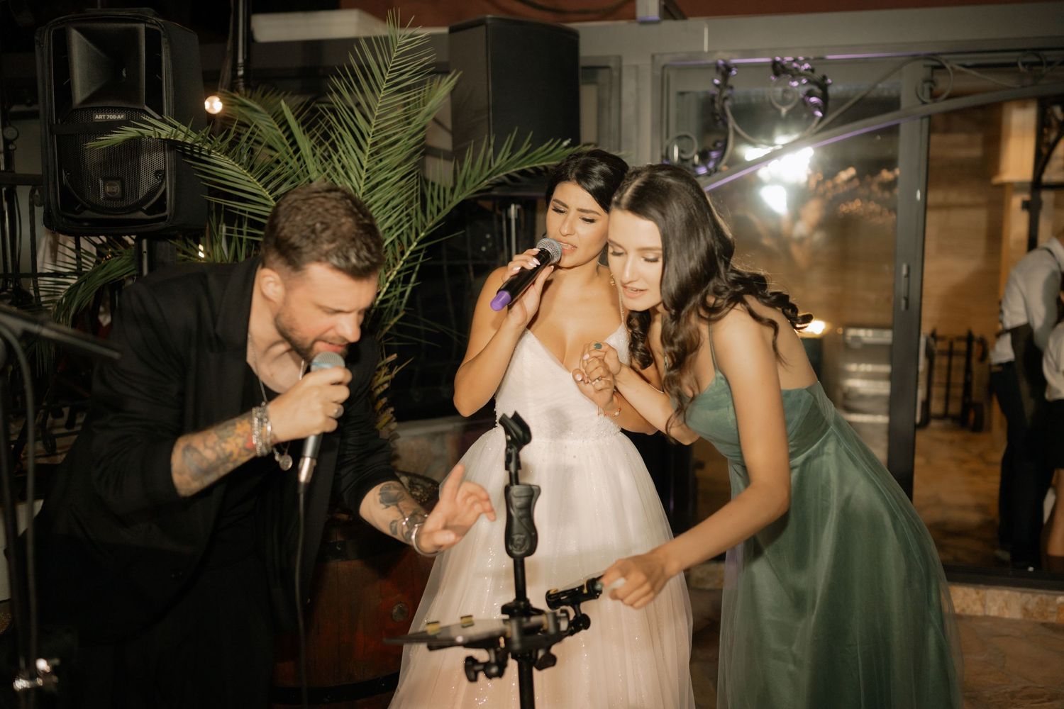 A couple shares an intimate dance together during their wedding celebration at an indoor venue.
