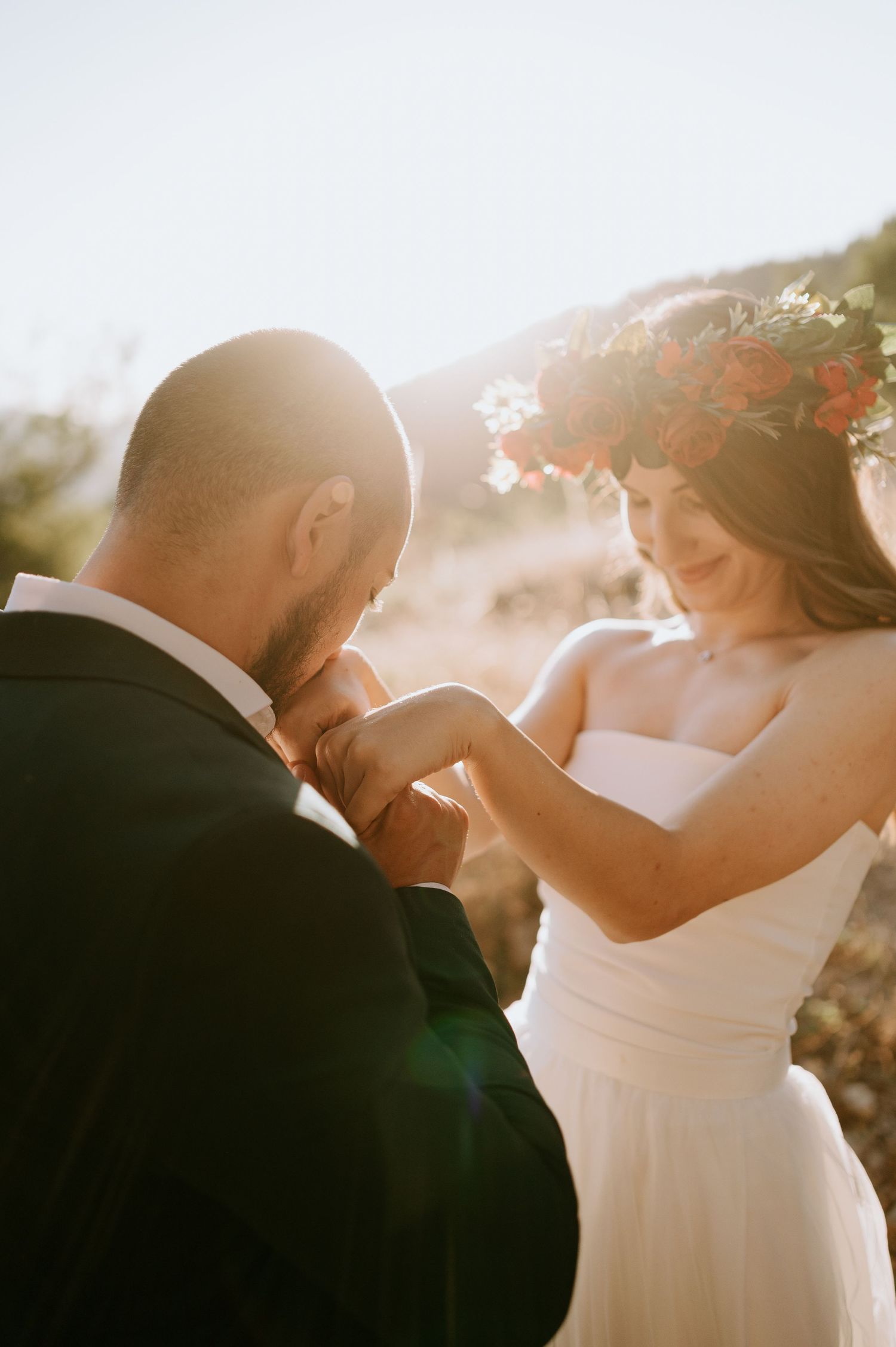 Backlit wedding portraits showing intimate moments between newlyweds at sunset.