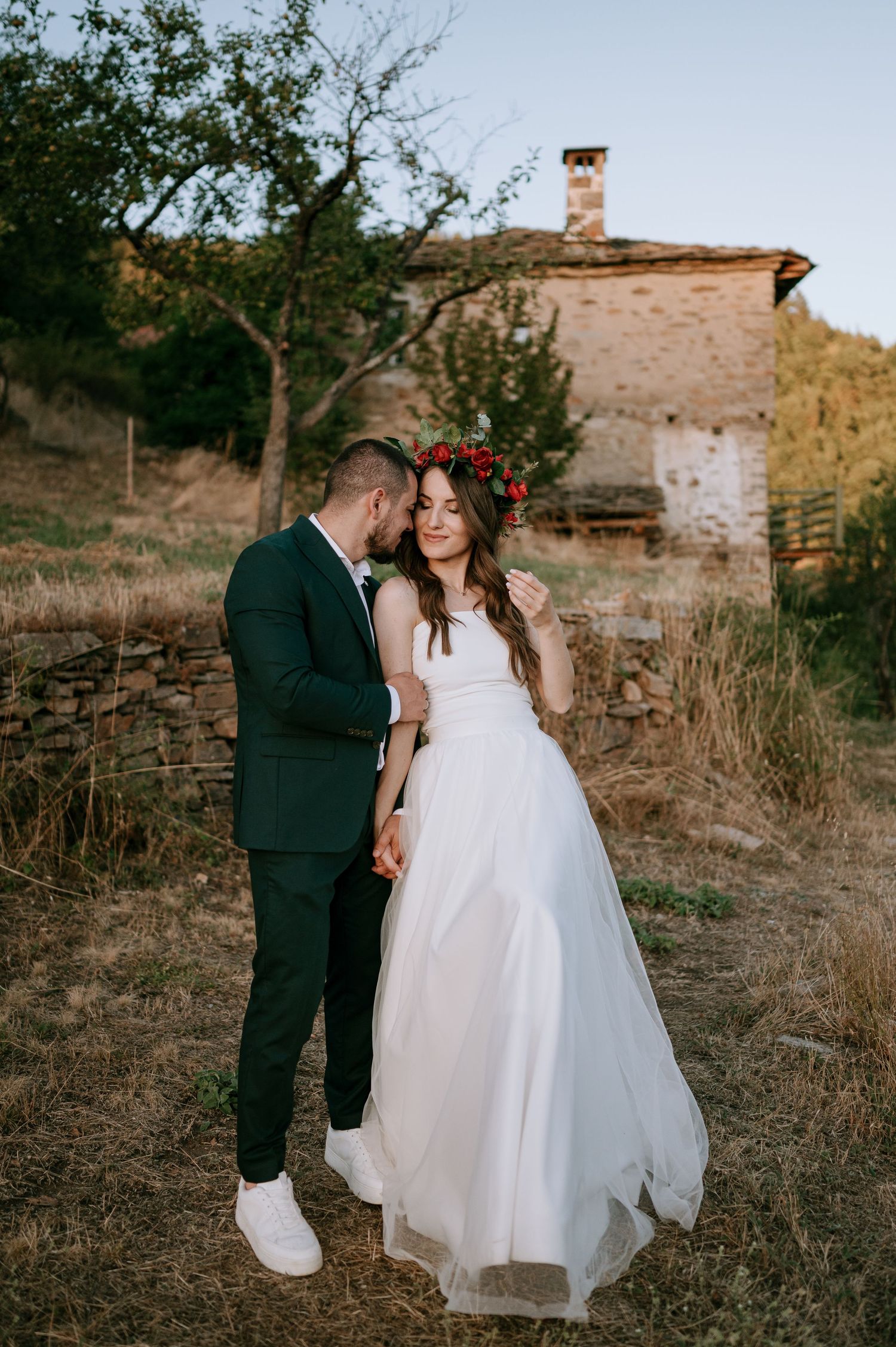 A romantic wedding photo series showing tender moments between a couple against a rustic stone wall backdrop.