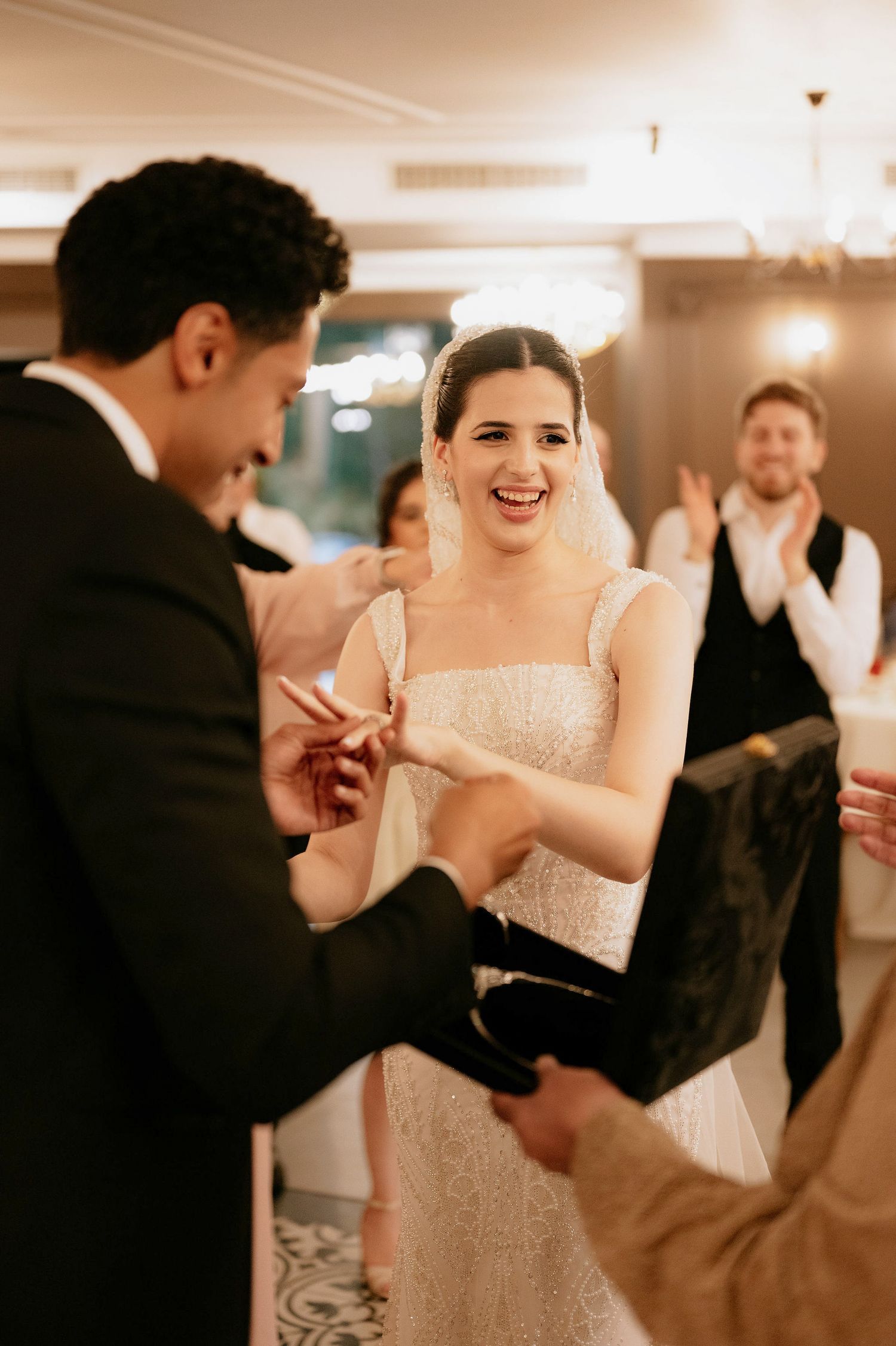 Candid moments of dancing and celebration at indoor wedding reception.