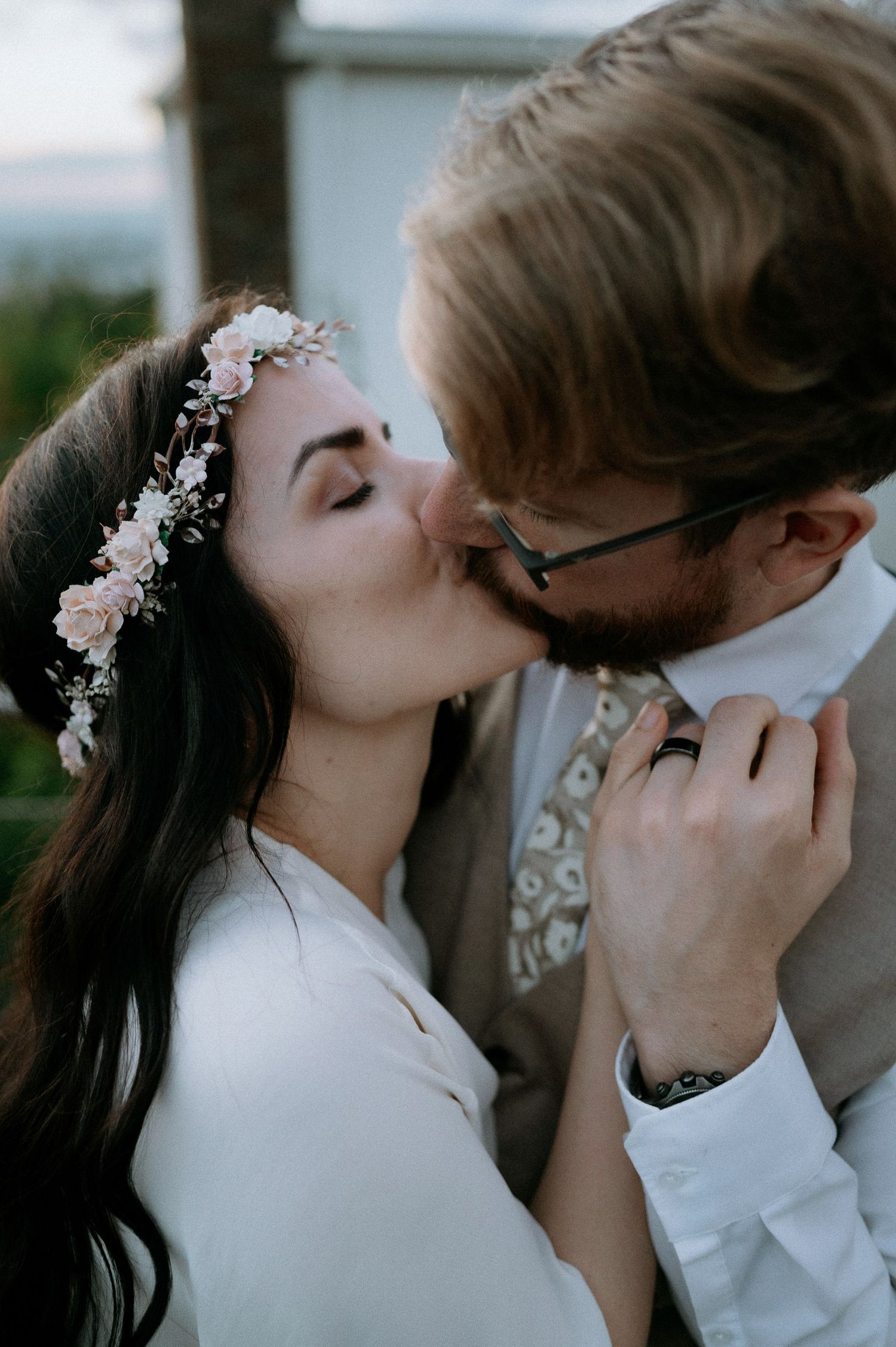 Intimate wedding portraits with delicate floral hair accessories and formal attire.