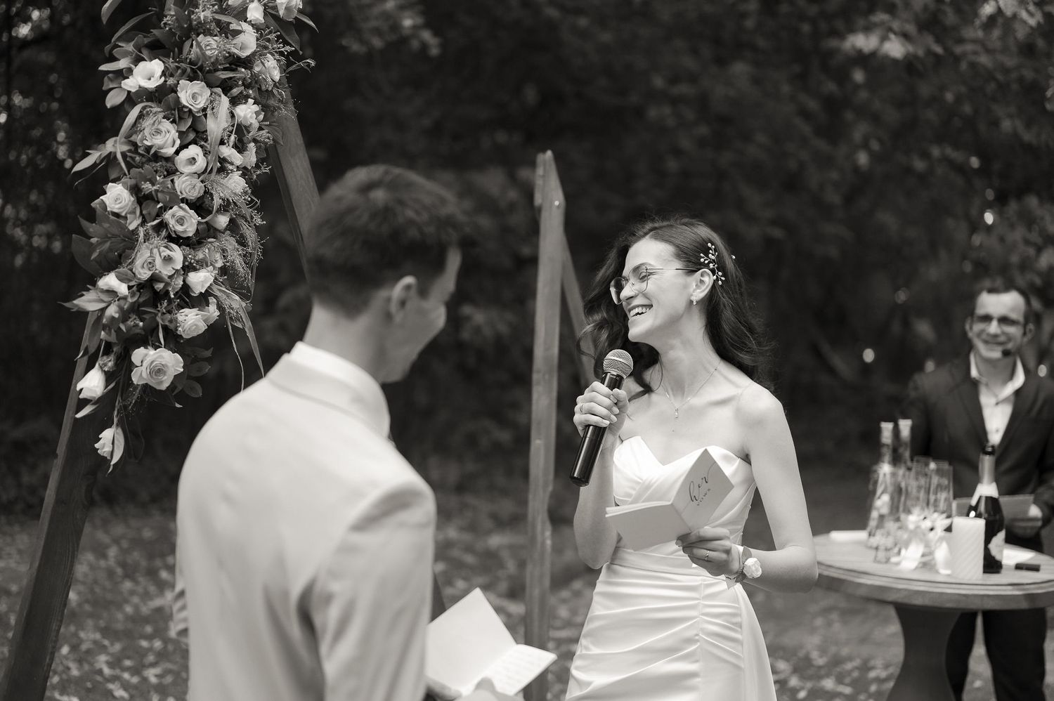 A couple shares an intimate moment during an outdoor garden wedding reception celebration.