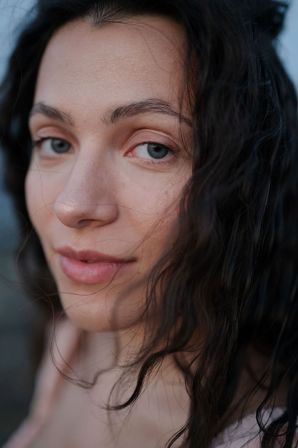 Close-up portrait series showing changing expressions with dark hair and natural lighting.